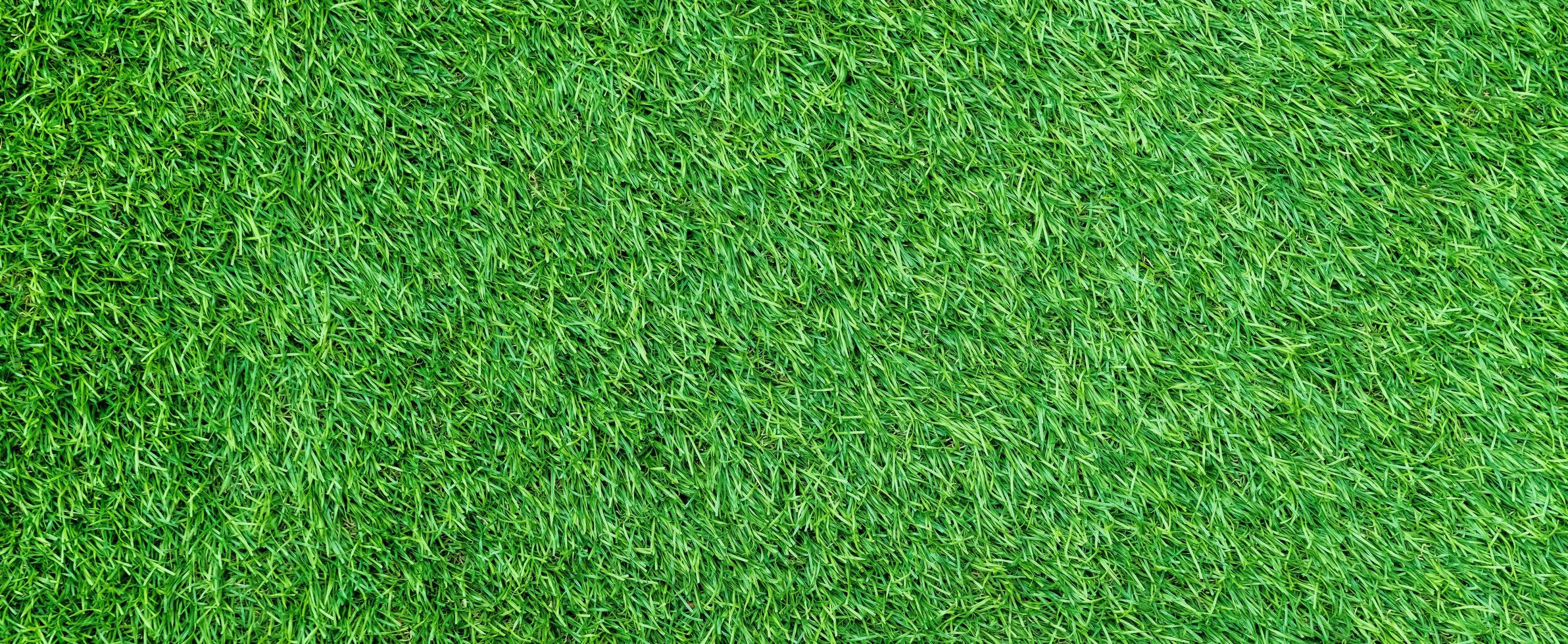 Panorama of green artificial turf flooring texture and background seamless photo