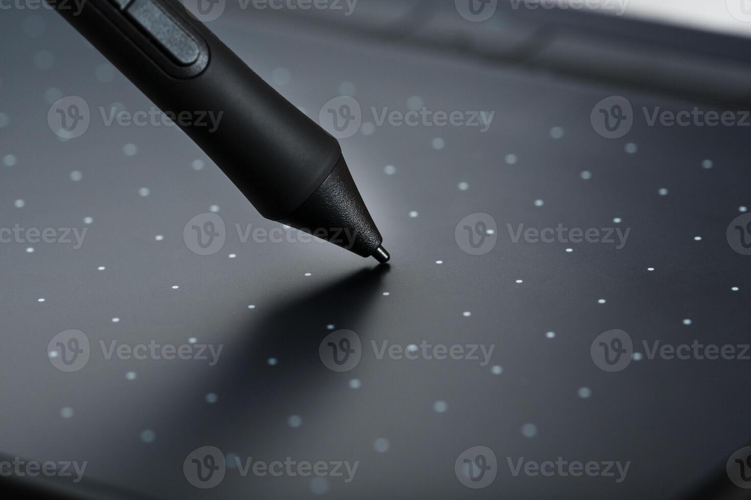 Pen and graphic tablet closeup on a gray textural background. Gadget