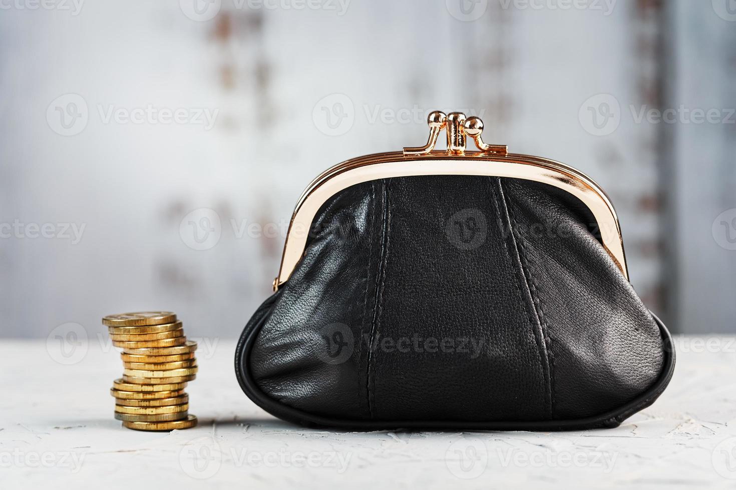 Wallet with gold coins on a gray background. Budget for investment in the future. photo