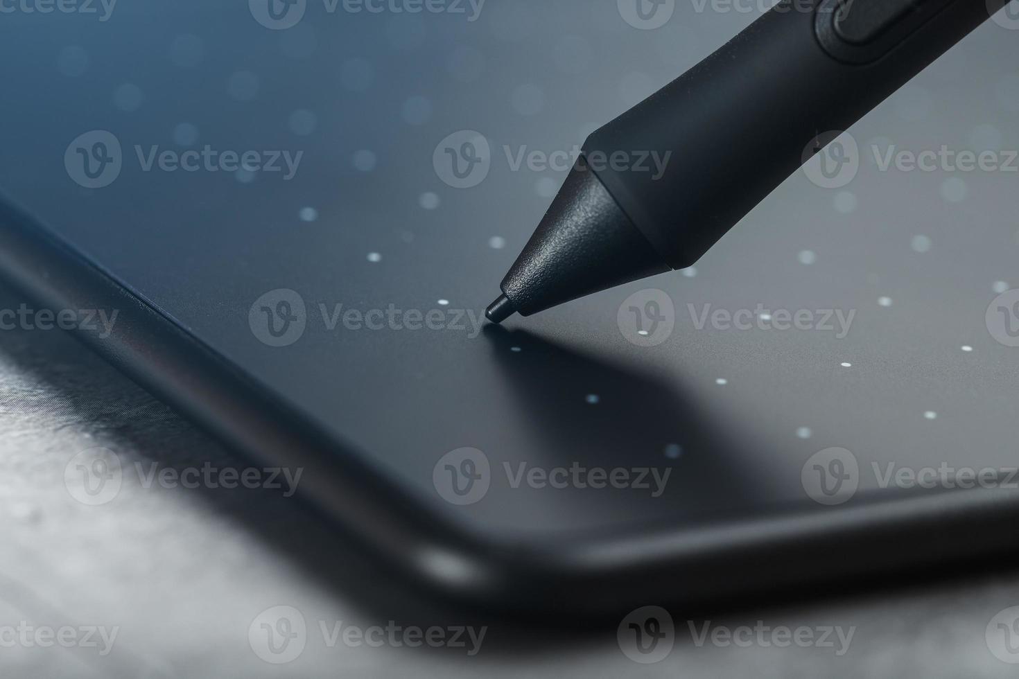 Pen and graphic tablet closeup on a gray textural background. Gadget