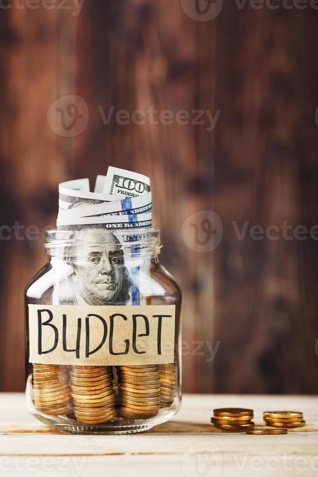 Piggy Bank with gold coins and dollars, with a sticker saying Budget photo