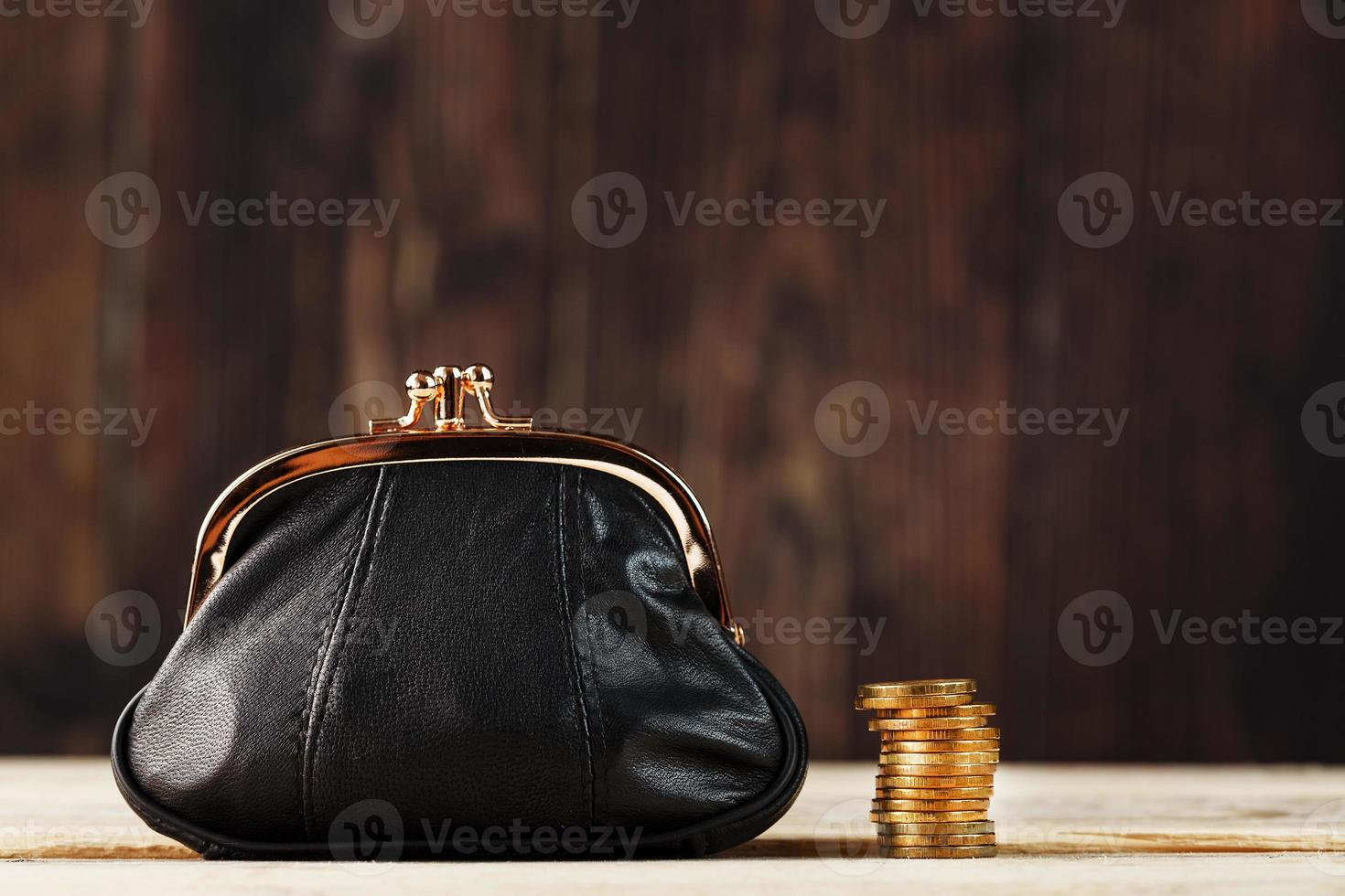 Purse with money and on a wooden table. Budget for investment in the future. photo