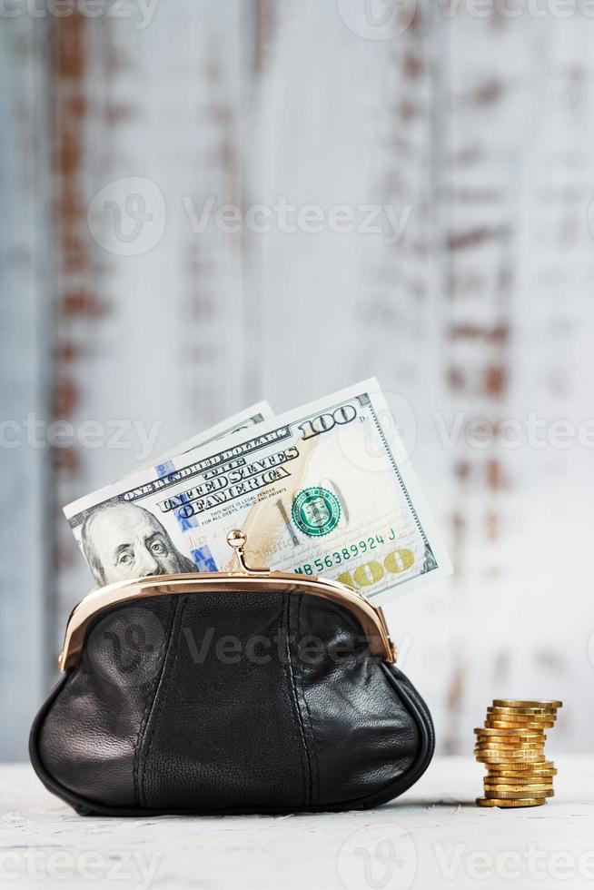 Wallet with money on a grey background. Saving your budget and saving for your dream. photo