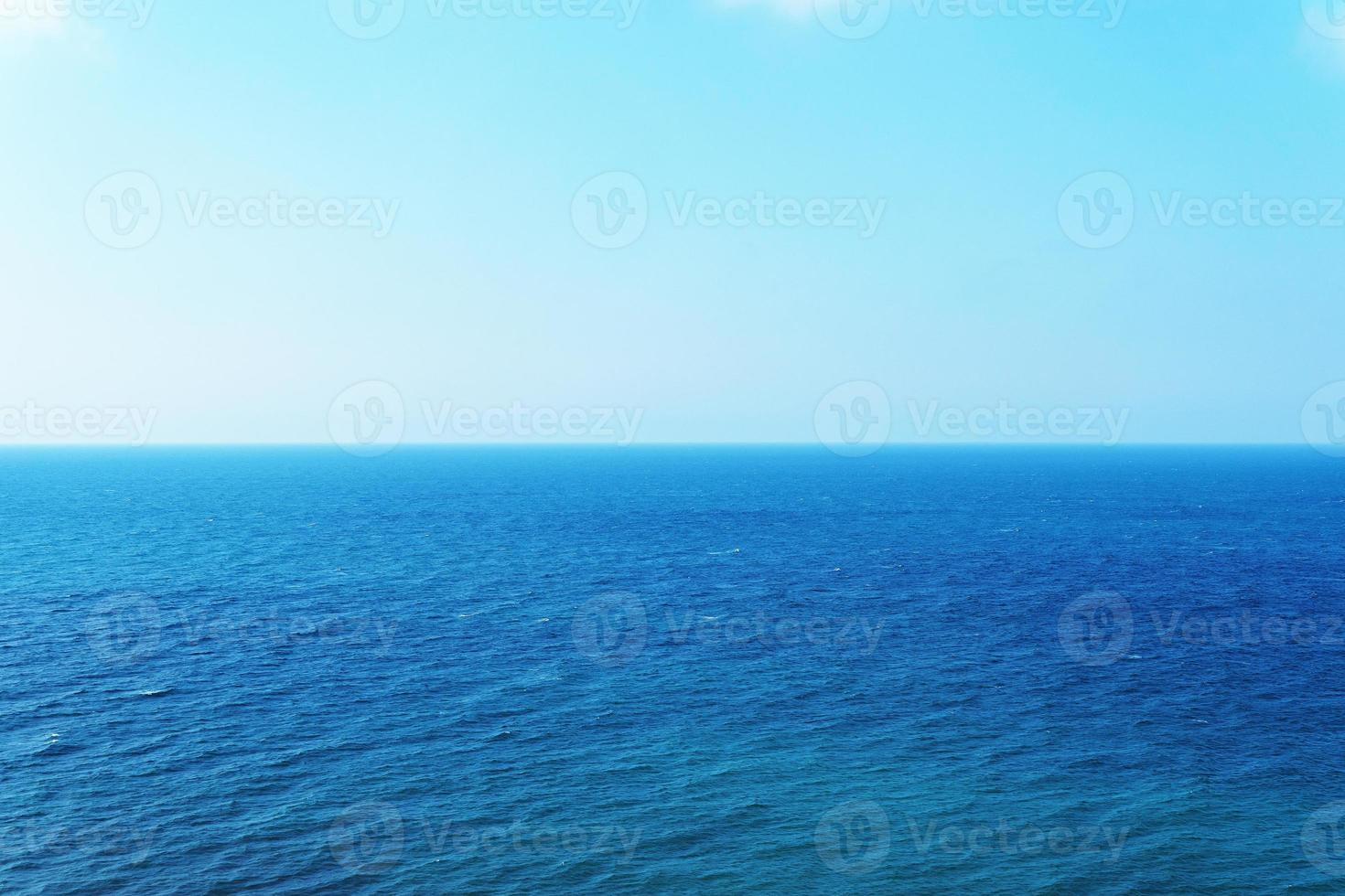 Blue sky over the sea with reflection. Peaceful sea of harmony texture to the water. photo