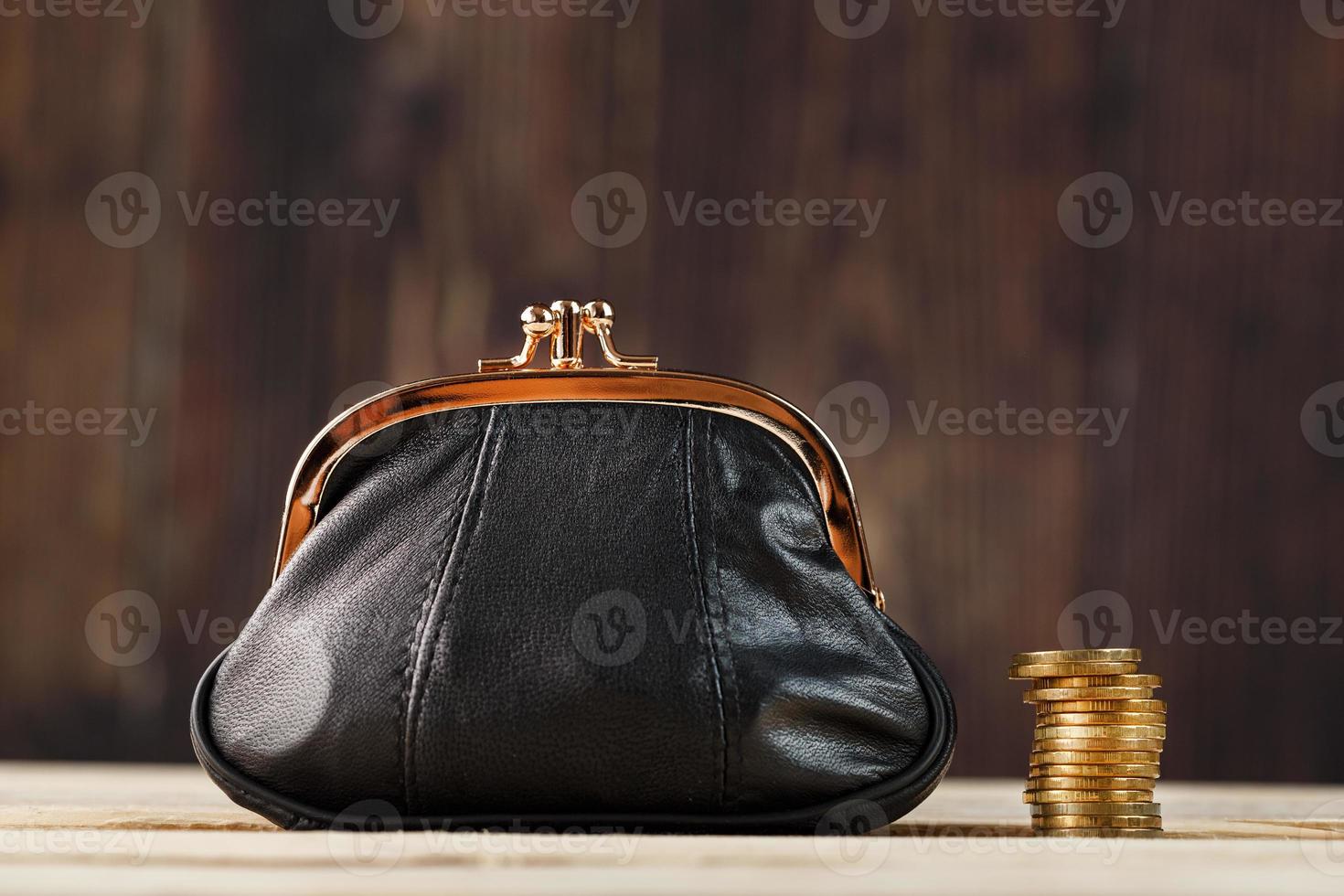 Purse with money and on a wooden table. Budget for investment in the future. photo