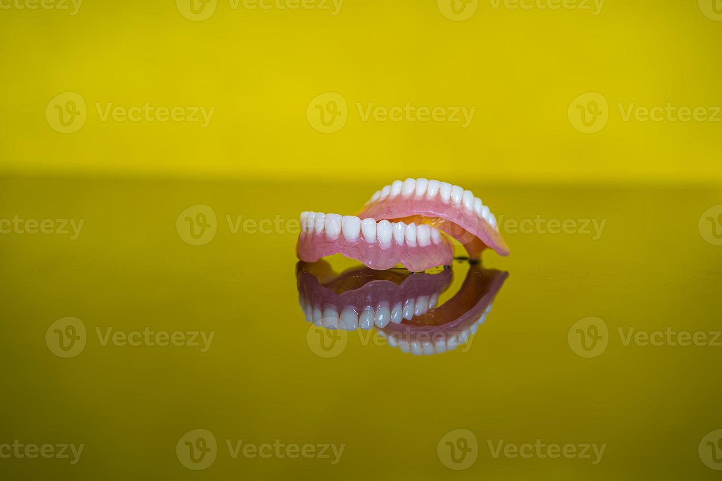 dentures closeup on a yellow background 13262570 Stock Photo at Vecteezy