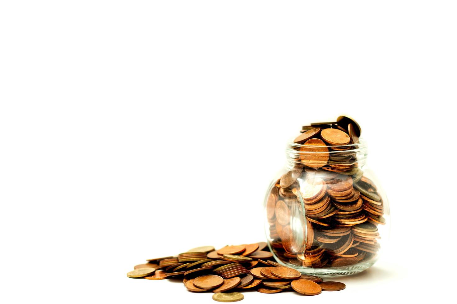 Many coins in bottle and a pile on ground white background, Money growing concept and sustainable investment, Business success and financial concept, Banking and economy idea photo