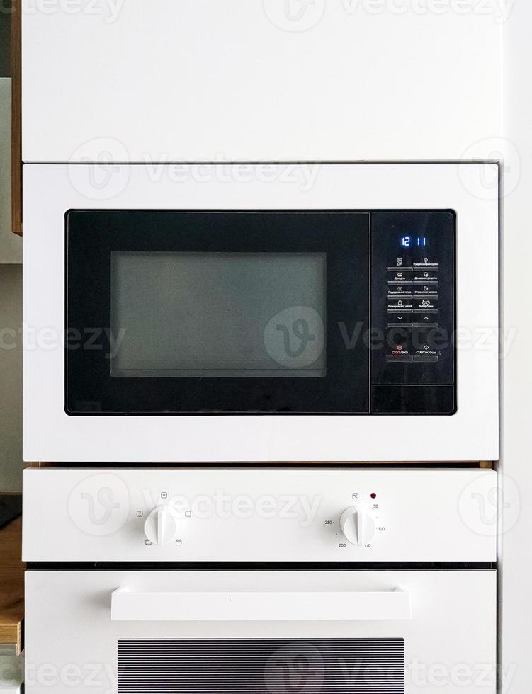 White microwave oven in modern scandi kitchen photo