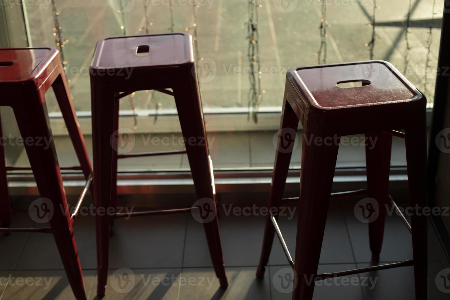 Chairs in bar. Red chairs in dining room. Metal seat. photo