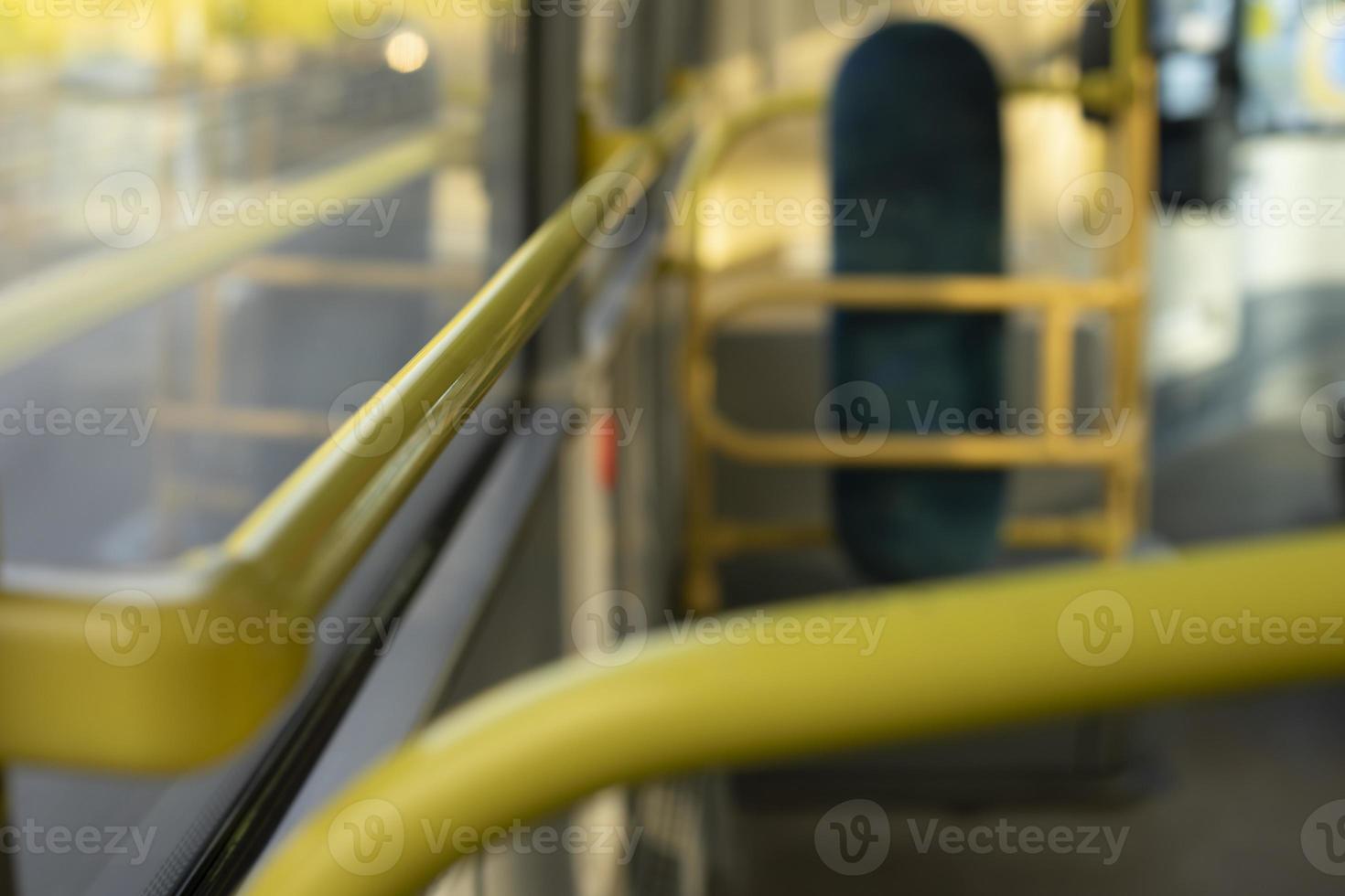 Interior of bus. Yellow handrail in transport. Public transport inside. photo