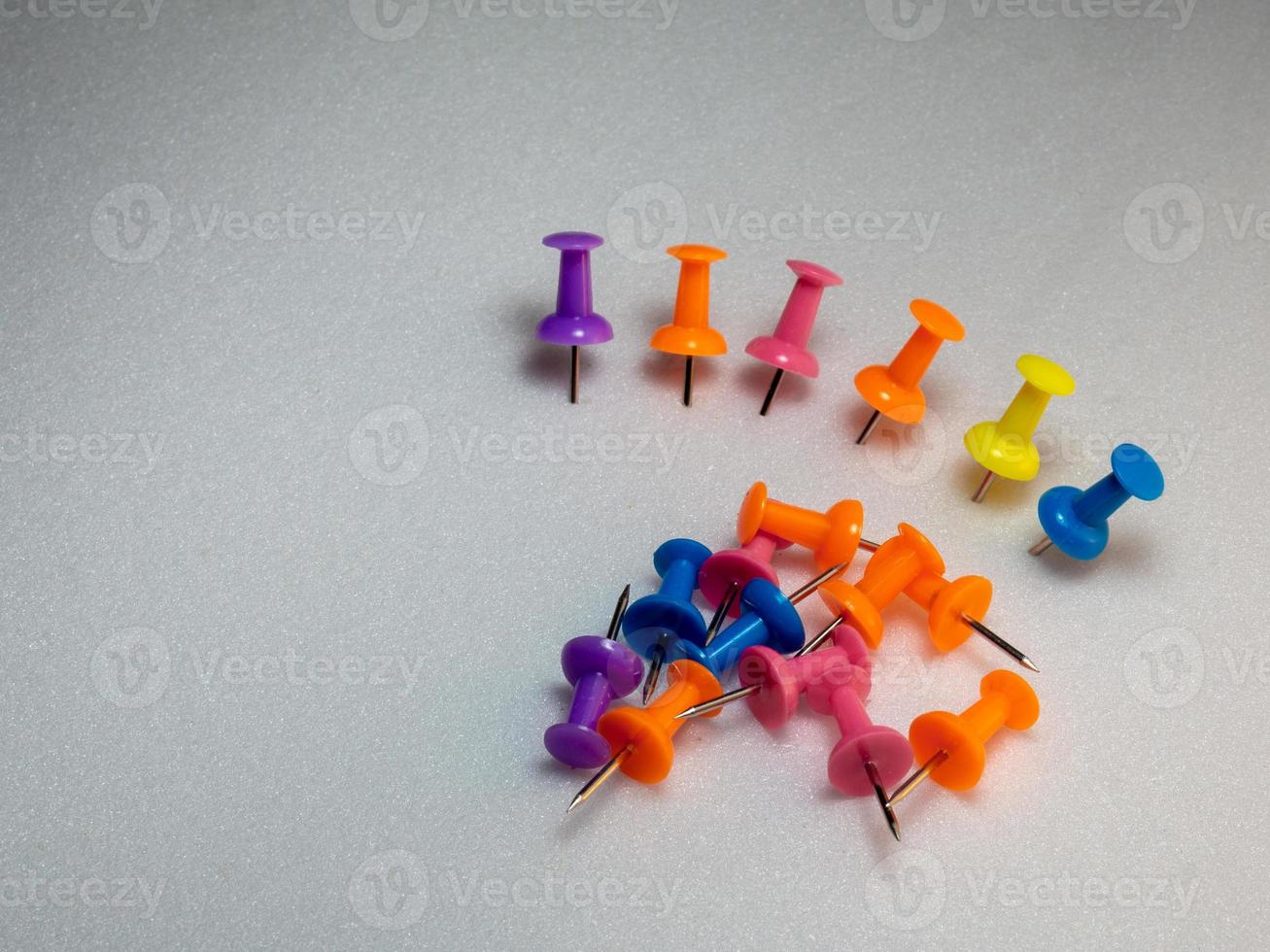 colored memothumb tacks. Stationery on white background. photo