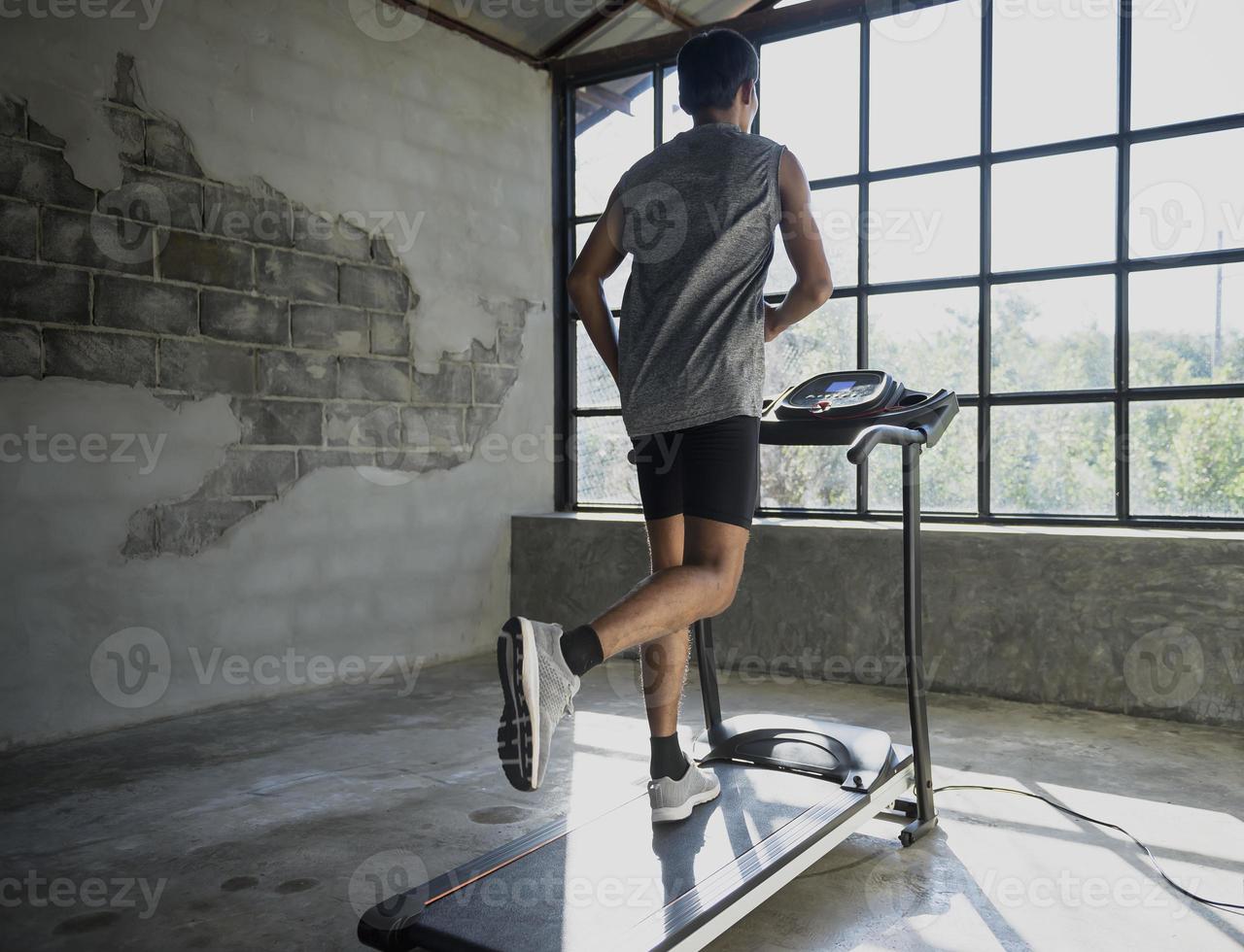 A man walking and exercising on a treadmill. photo