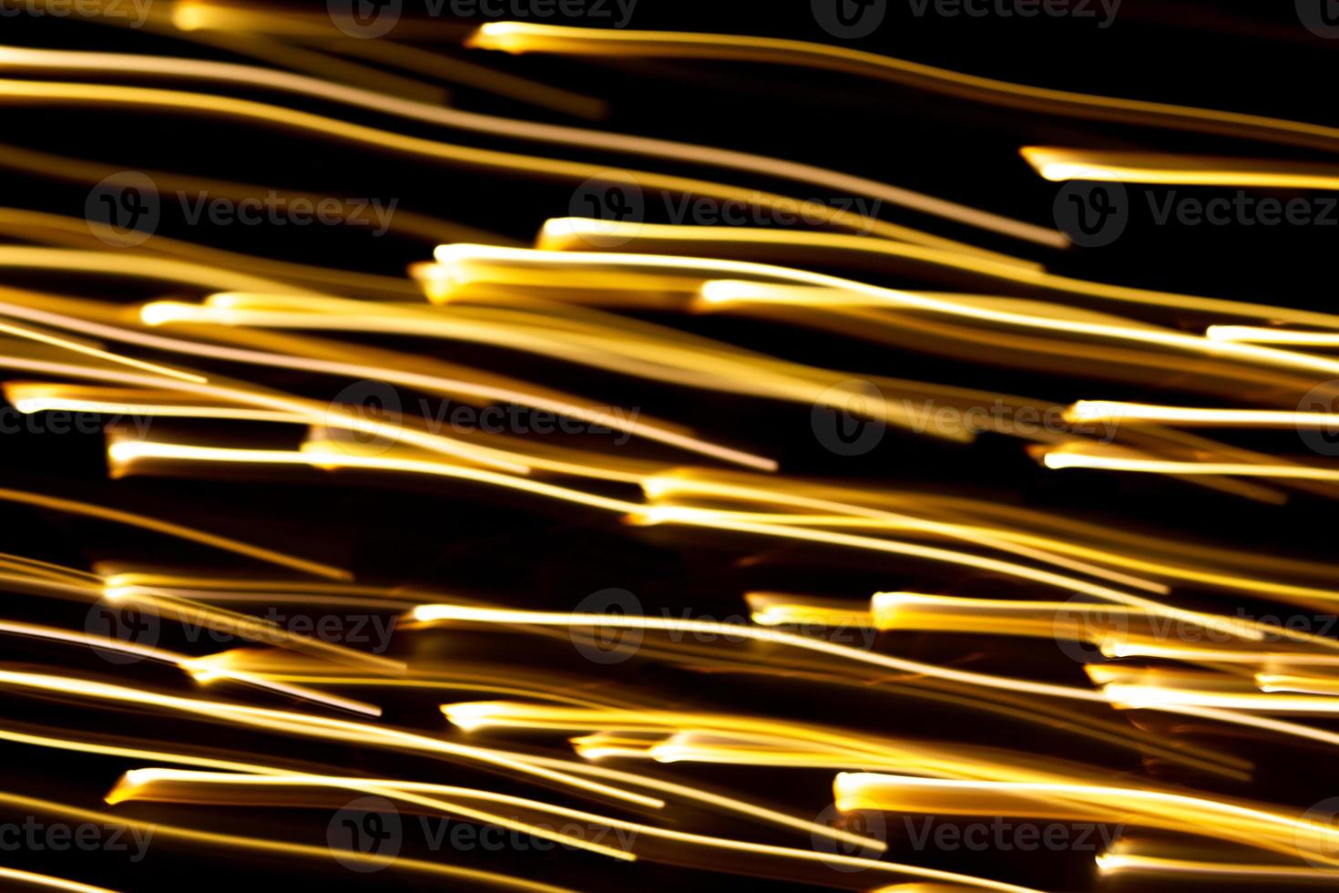 Golden rays of light go up or down. Motion effect, technology. Defocused background, overlay photo