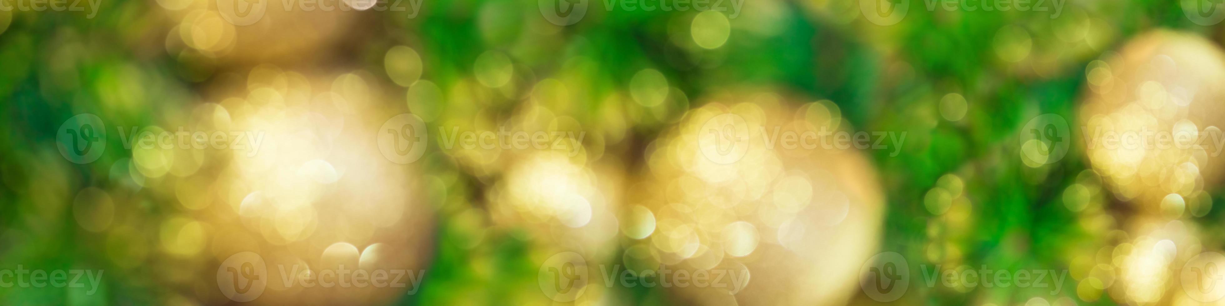 Blurred banner with Christmas tree and golden toys. Soft focus. New year background. Copy space photo