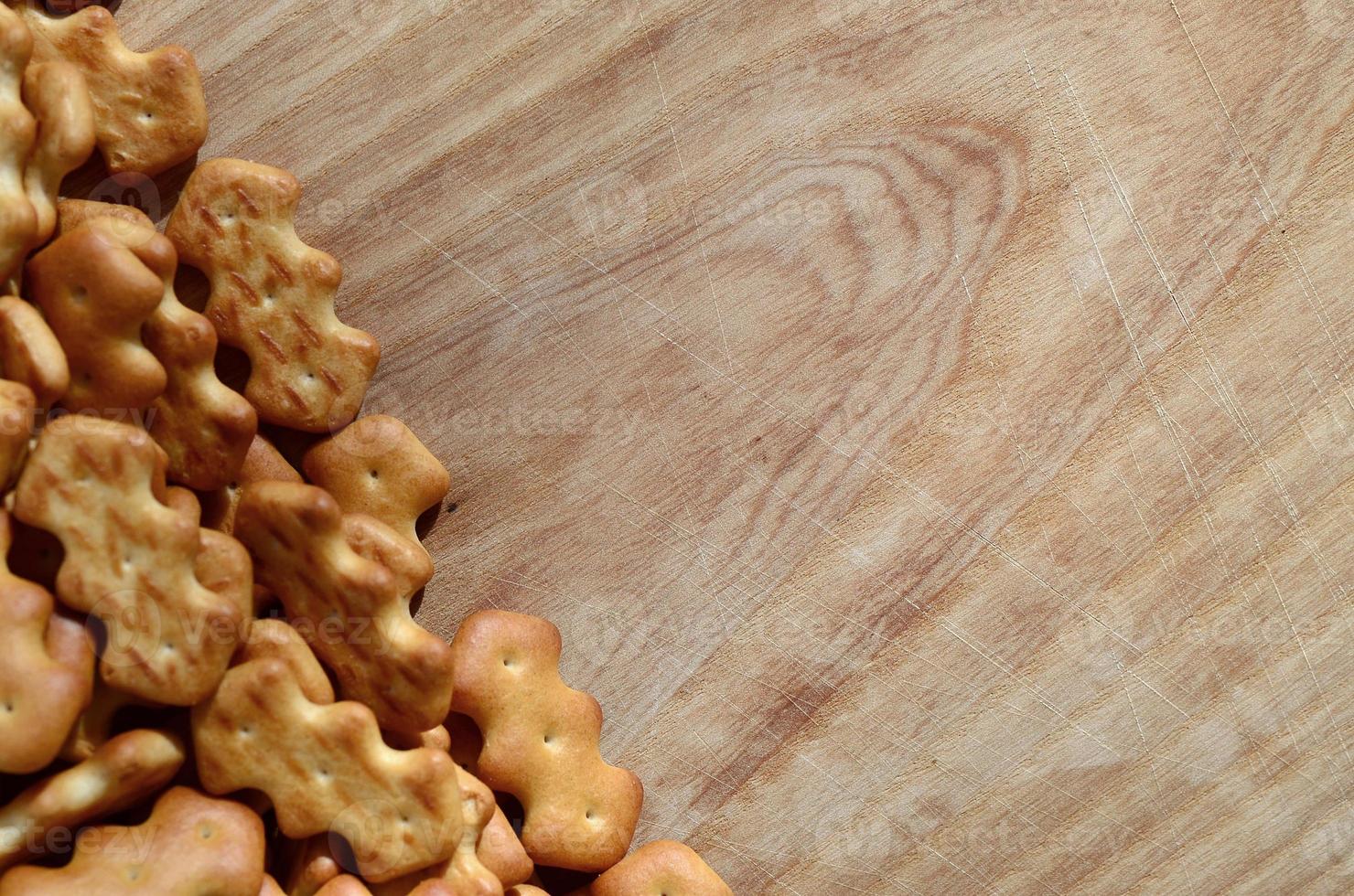 Many salted crackers on a cutting board with copy space photo