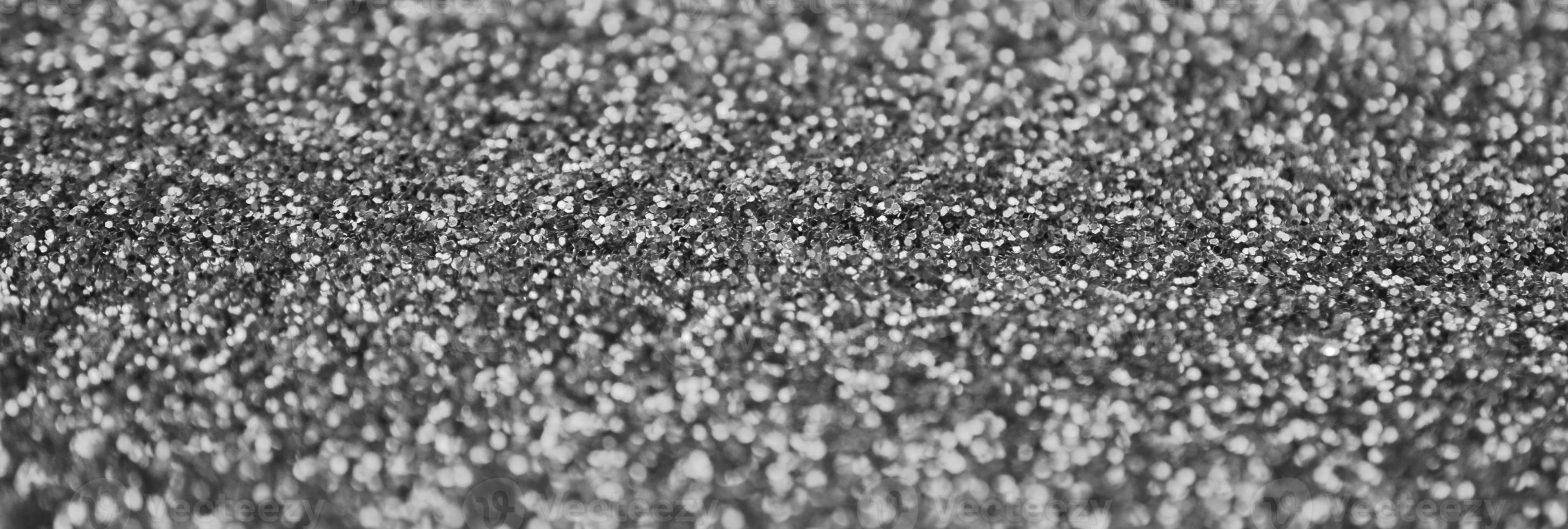 Silver decorative sequins. Background image with shiny bokeh lights from small elements photo