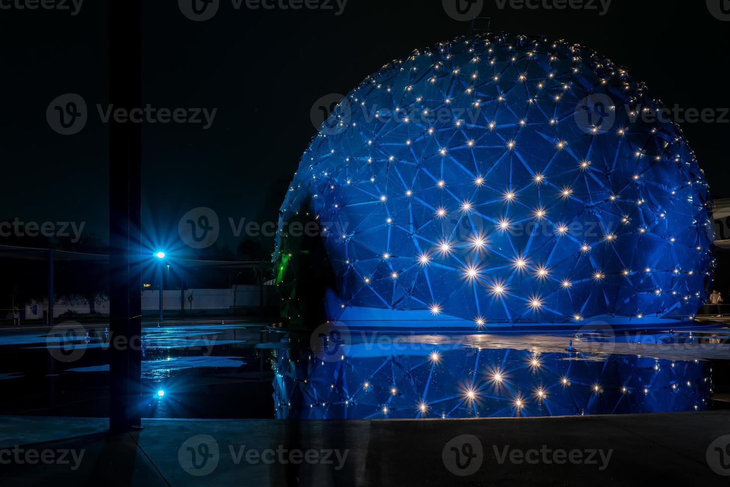 dome shaped building, with colored lights, reflection in water, parametric skin mexico photo