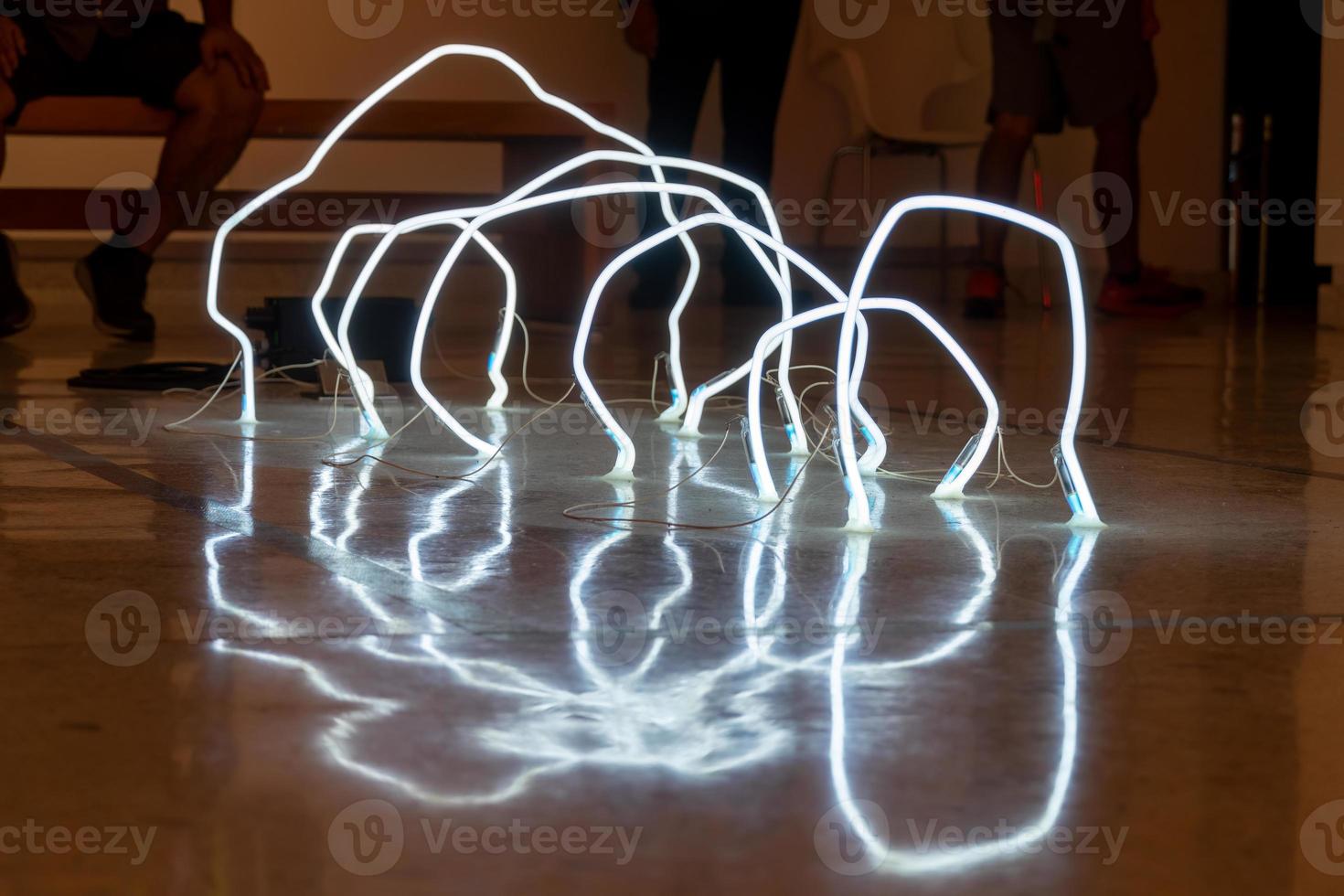 leds on the floor arranged in irregular arcs, reflections on the polished floor photo