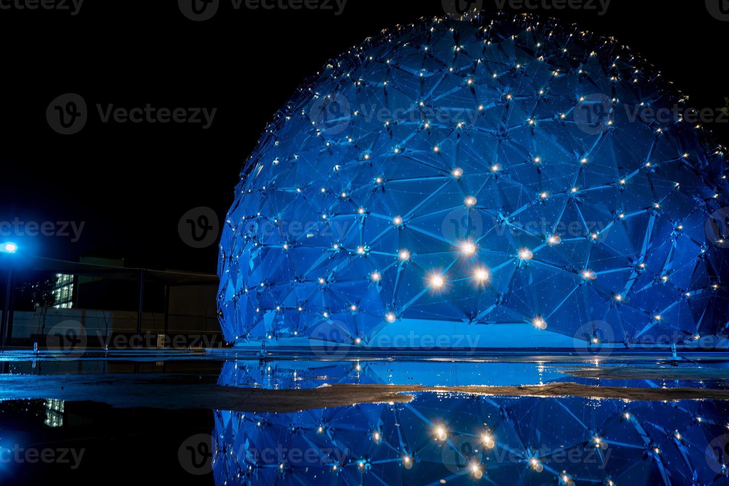 dome shaped building, with colored lights, reflection in water, parametric skin mexico photo
