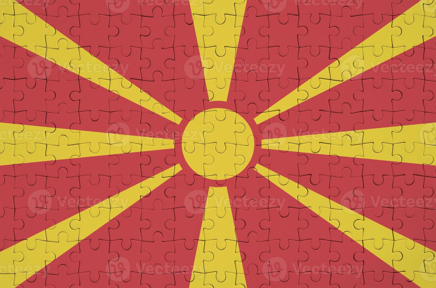 Macedonia flag  is depicted on a folded puzzle photo