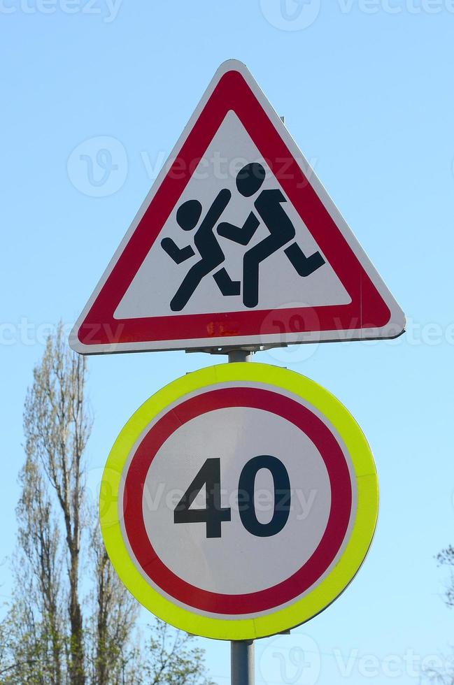 Road sign with the number 40 and the image of the children who run across the road photo