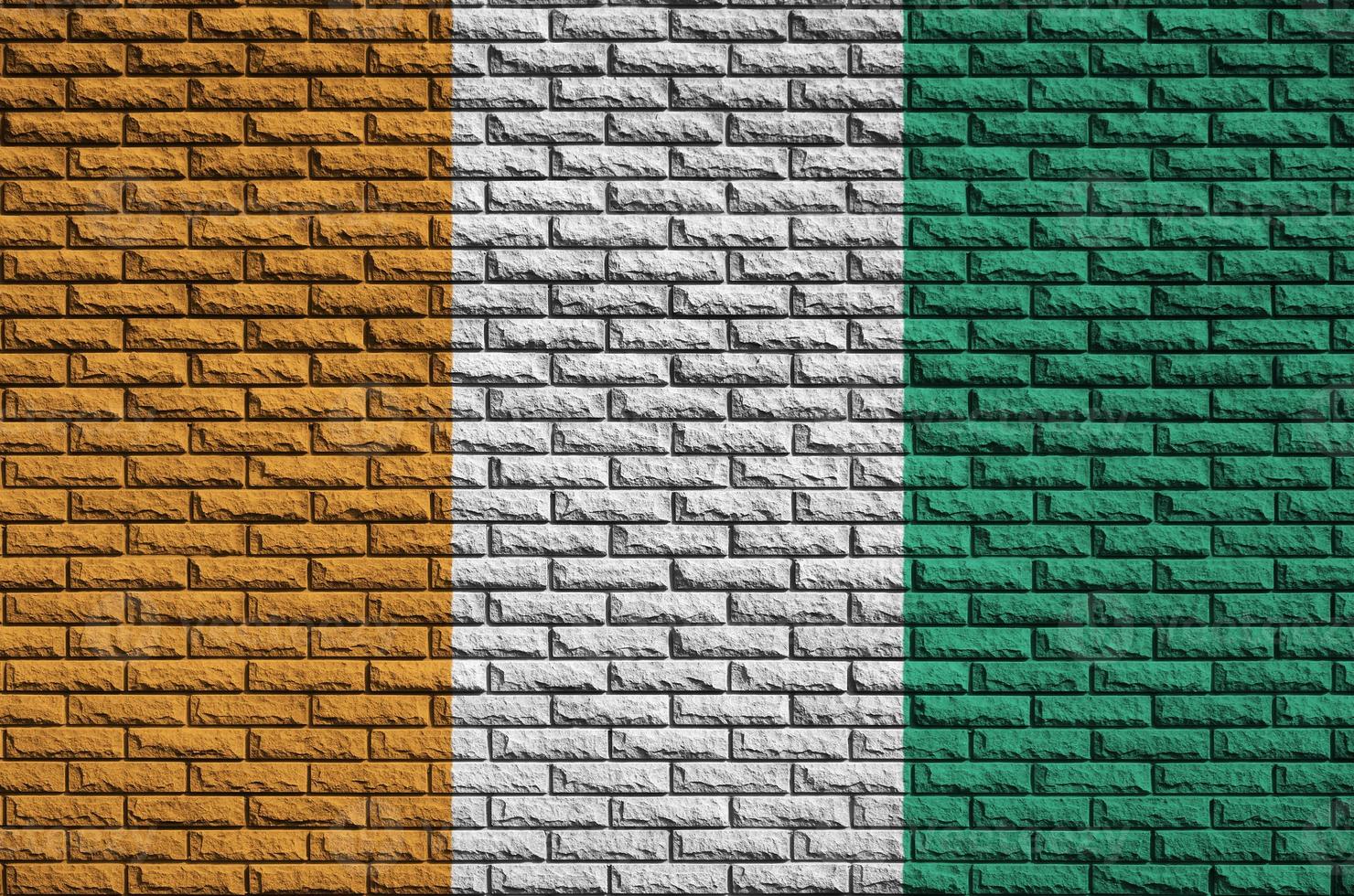 Ivory Coast flag is painted onto an old brick wall photo