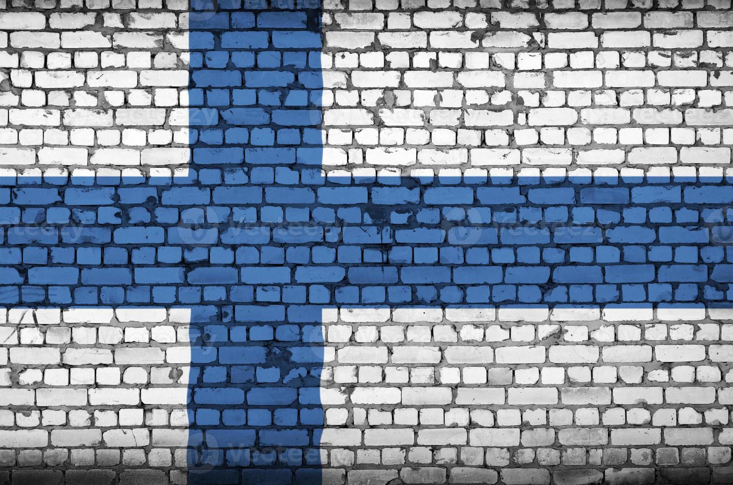 Finland flag is painted onto an old brick wall photo