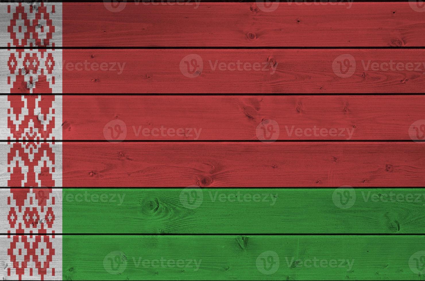 Belarus flag depicted in bright paint colors on old wooden wall. Textured banner on rough background photo