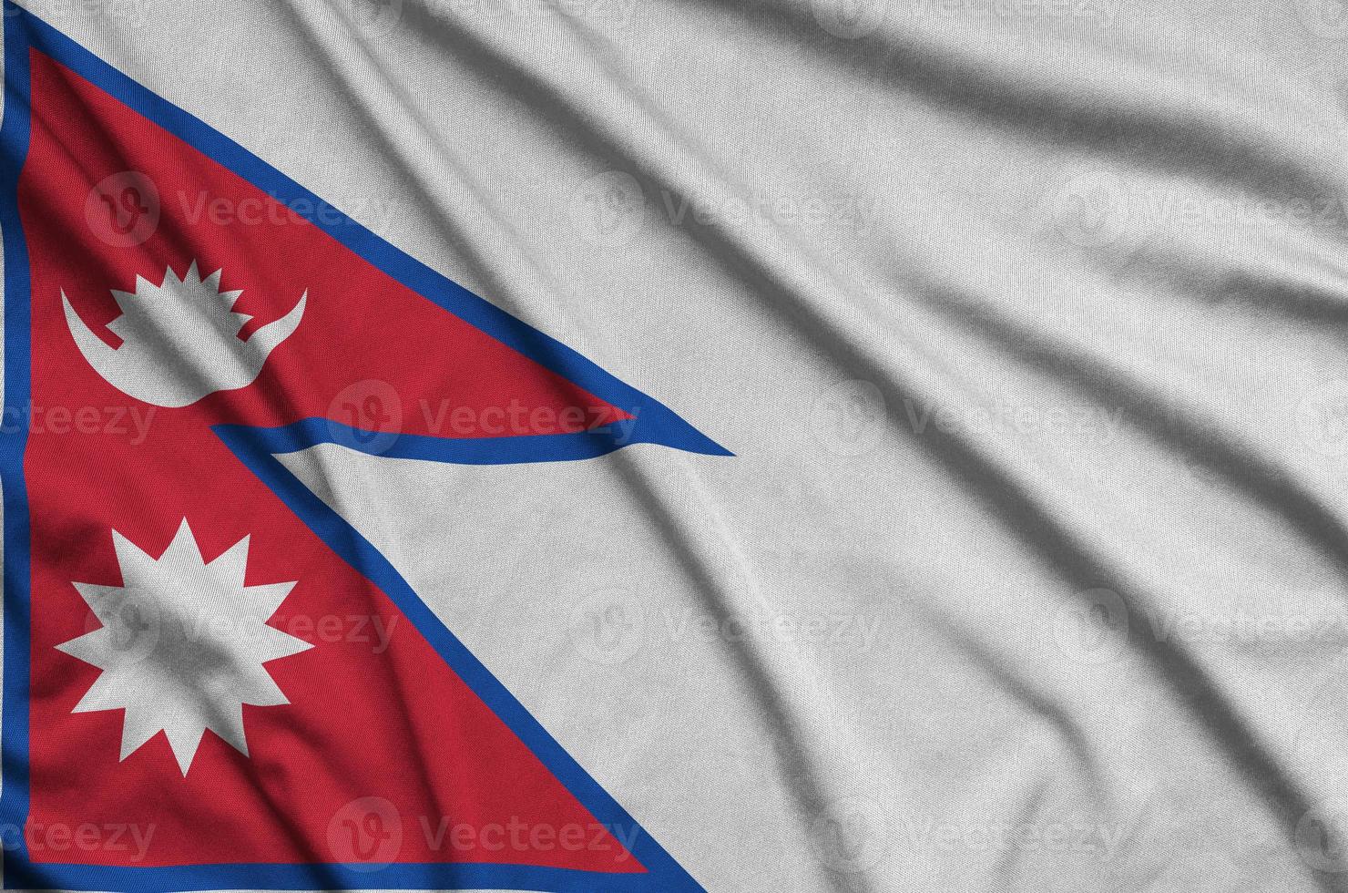 Nepal flag  is depicted on a sports cloth fabric with many folds. Sport team banner photo