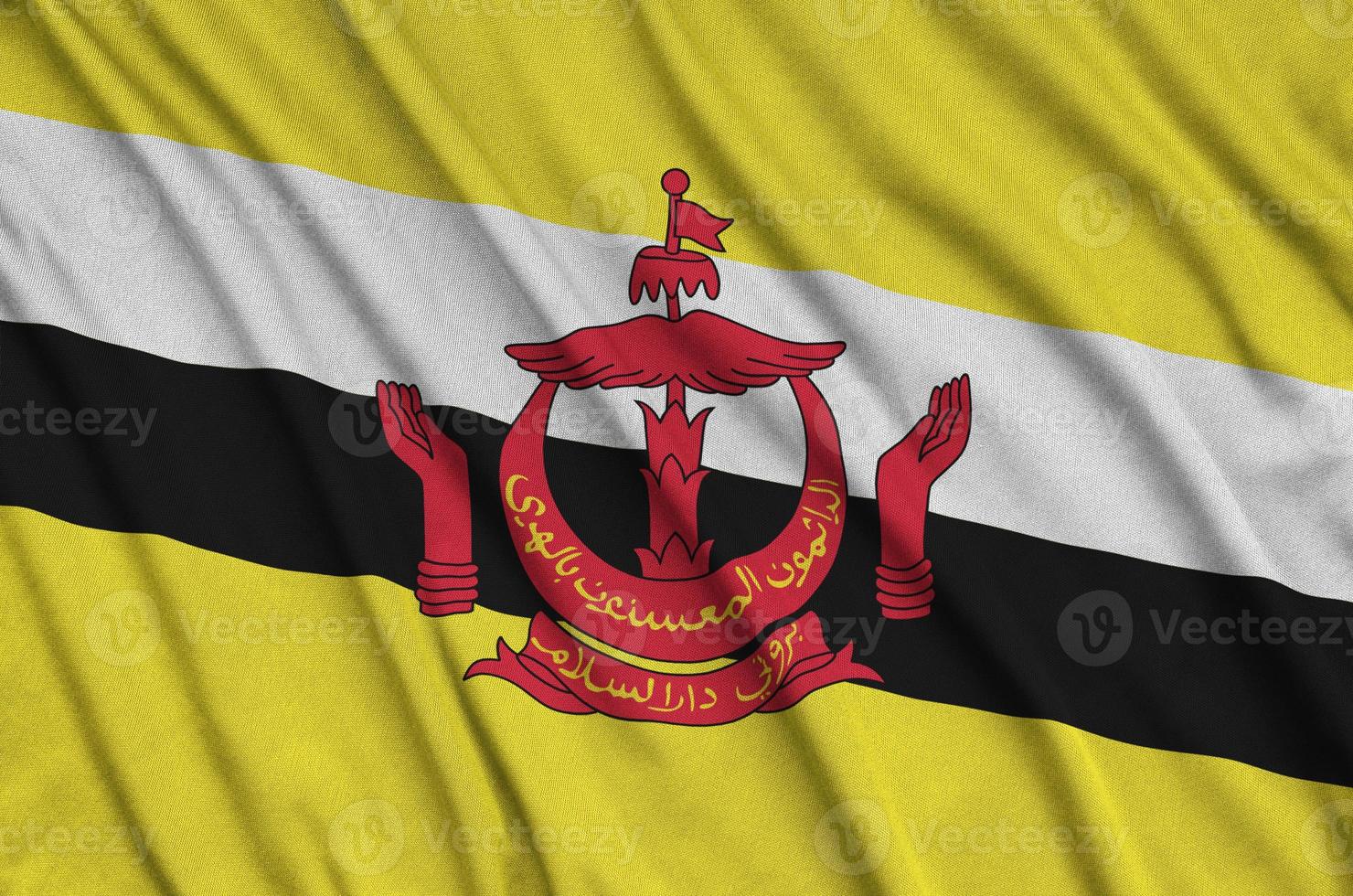 Brunei Darussalam flag  is depicted on a sports cloth fabric with many folds. Sport team banner photo