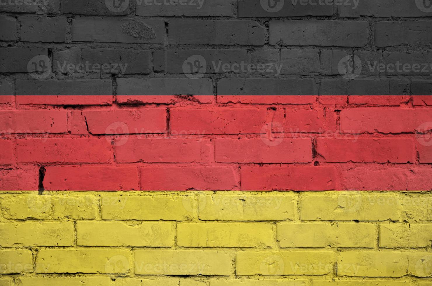 Germany flag is painted onto an old brick wall photo