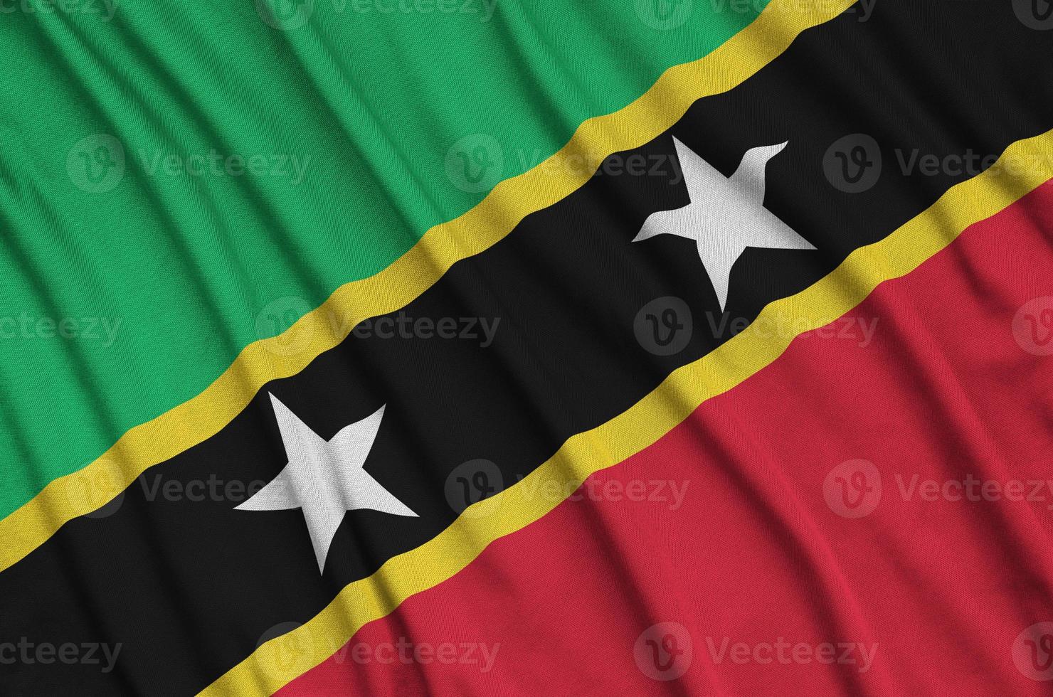 Saint Kitts and Nevis flag  is depicted on a sports cloth fabric with many folds. Sport team banner photo