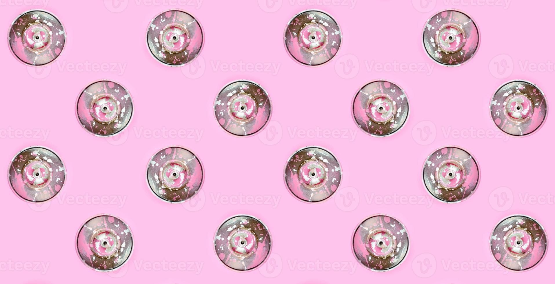Many used spray cans for graffiti drawing lies on a pastel colored backgroung. Street art painting concept. Minimal flat lay pattern. Top view photo