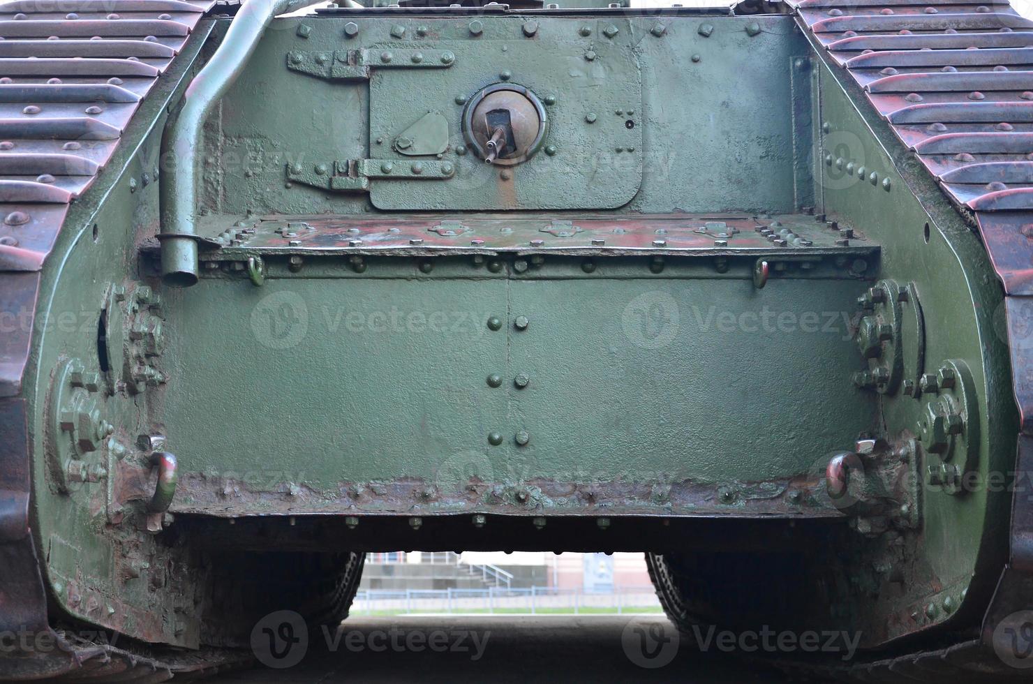 Texture of tank side wall, made of metal and reinforced with a multitude of bolts and rivets photo