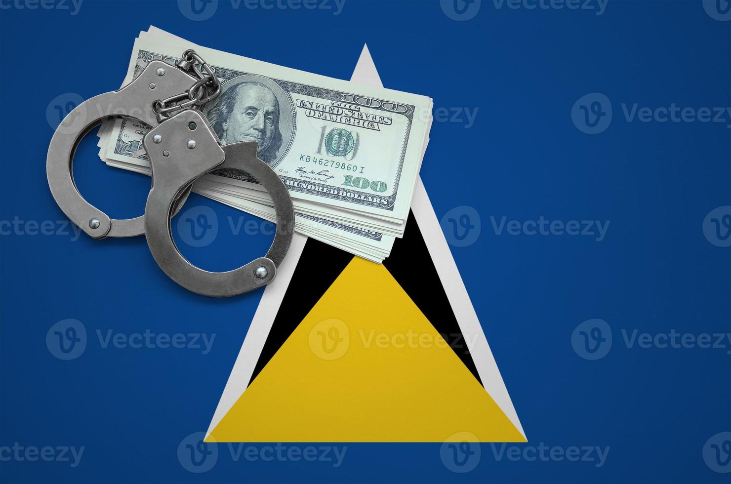 Saint Lucia flag  with handcuffs and a bundle of dollars. The concept of breaking the law and thieves crimes photo