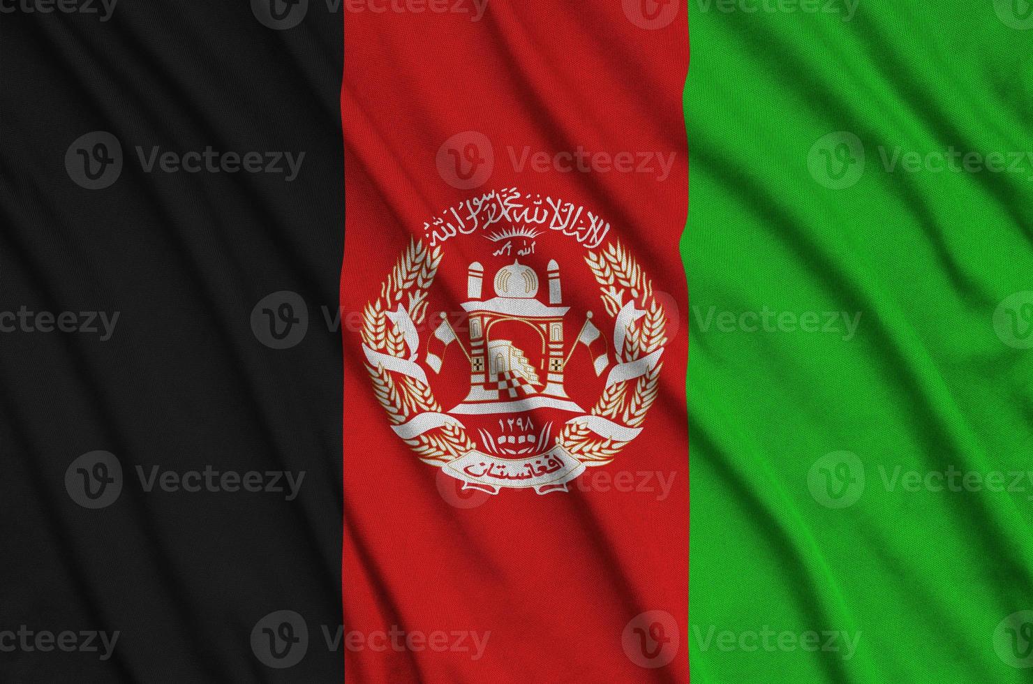 Afghanistan flag is depicted on a sports cloth fabric with many folds. Sport team banner photo