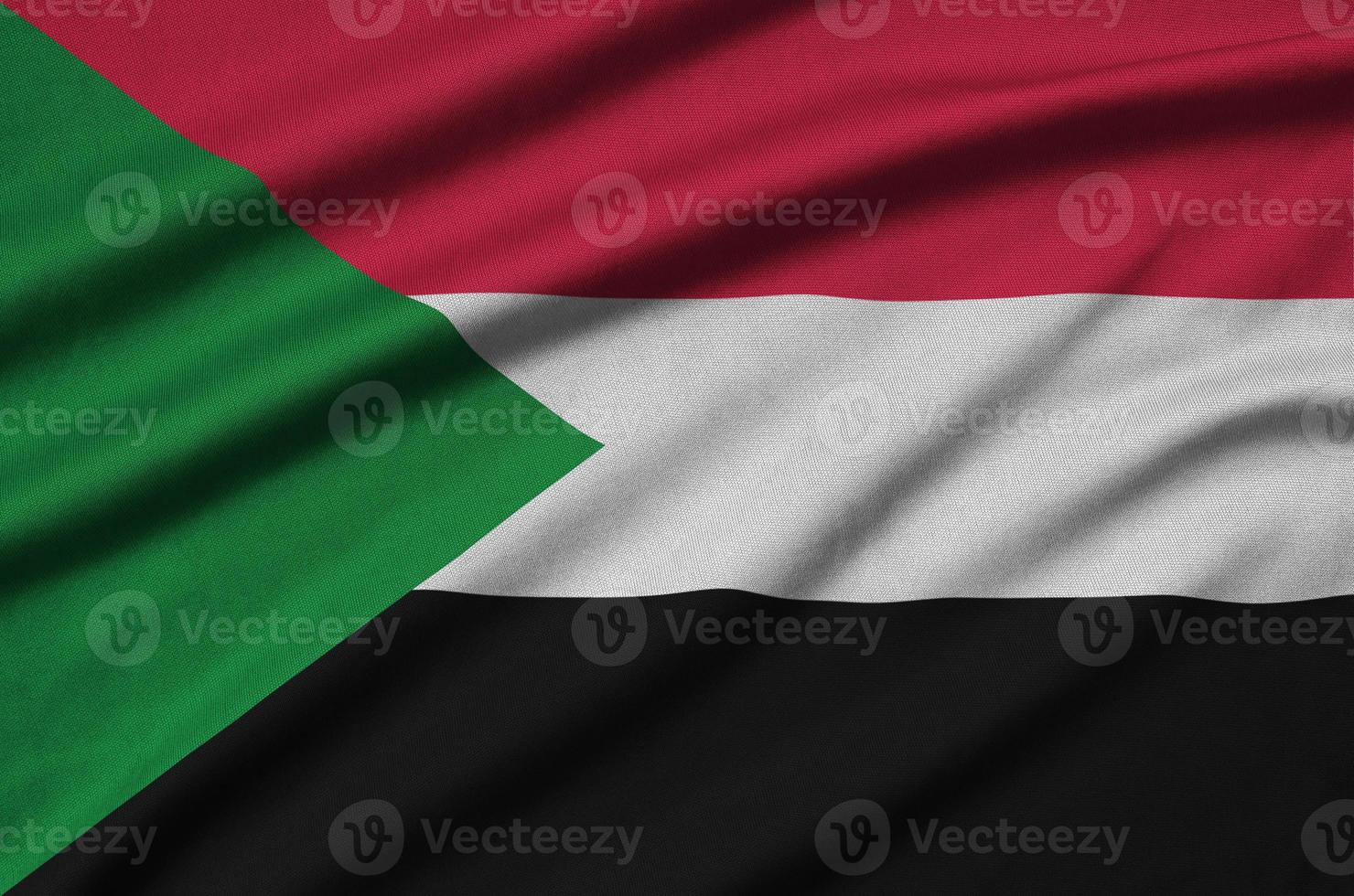 Sudan flag  is depicted on a sports cloth fabric with many folds. Sport team banner photo
