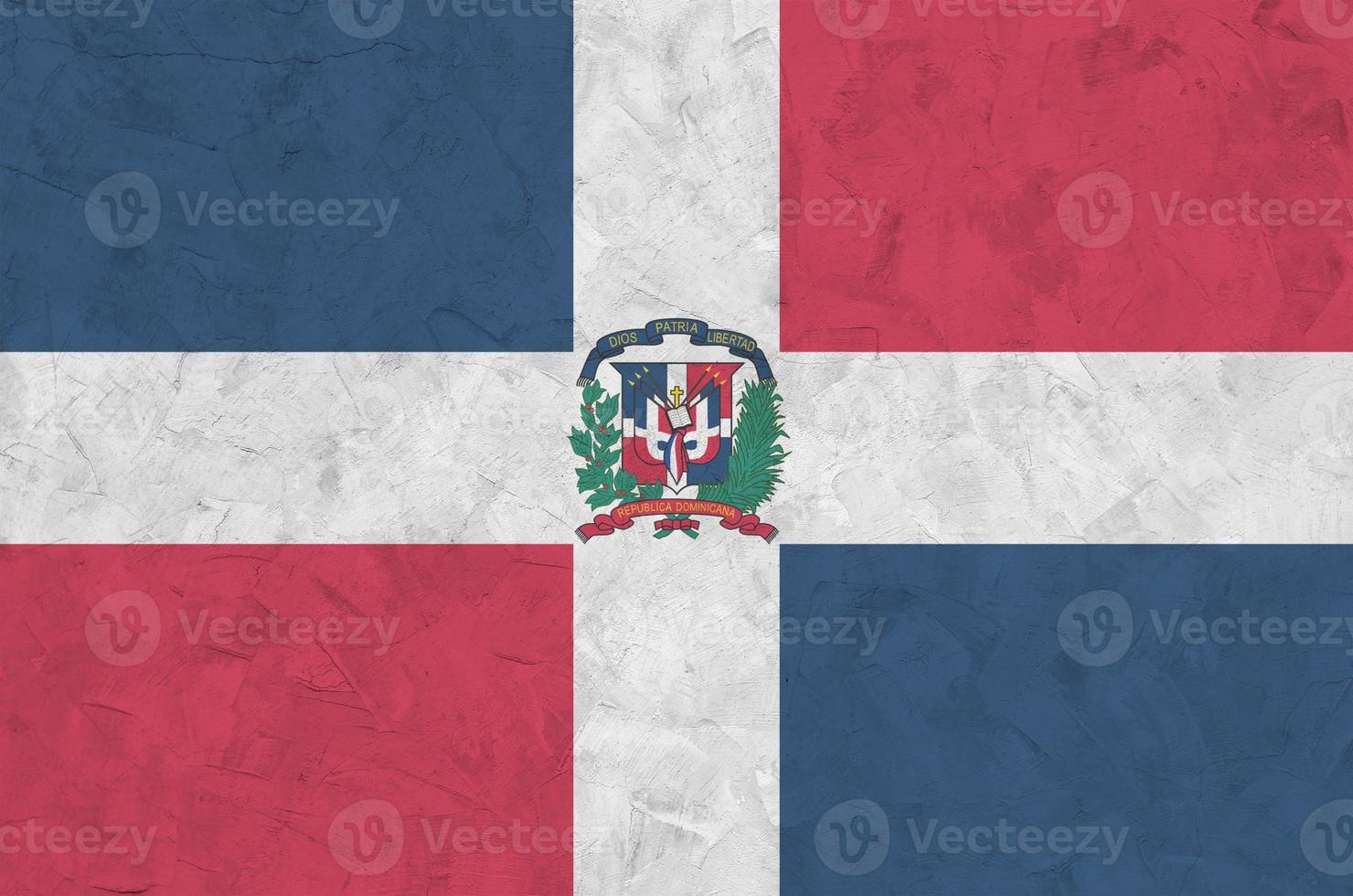 Dominican Republic flag depicted in bright paint colors on old relief plastering wall. Textured banner on rough background photo