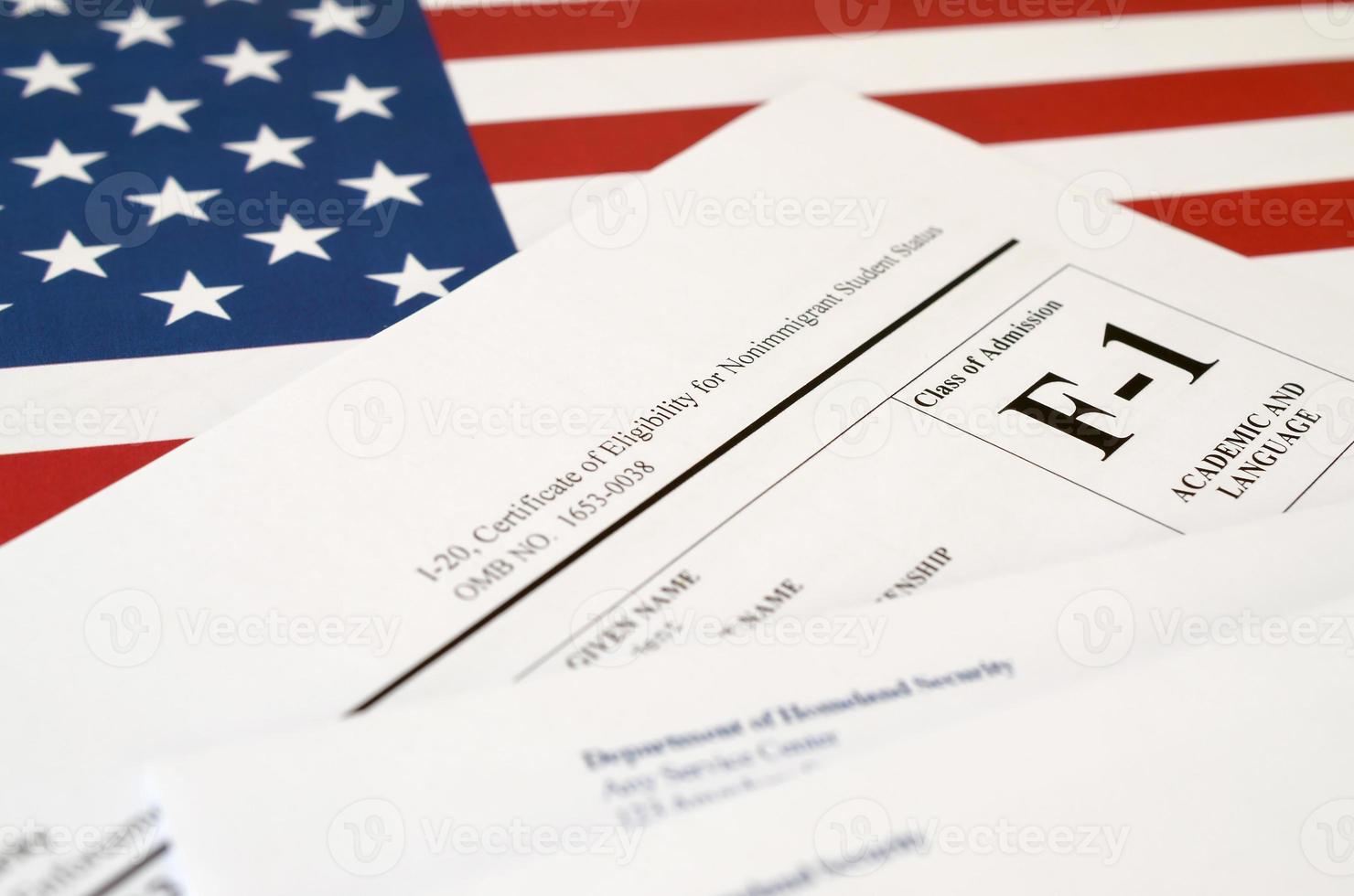 I-20 Certificate of eligibility for nonimmigrant student status blank form lies on United States flag with envelope from Department of Homeland Security photo