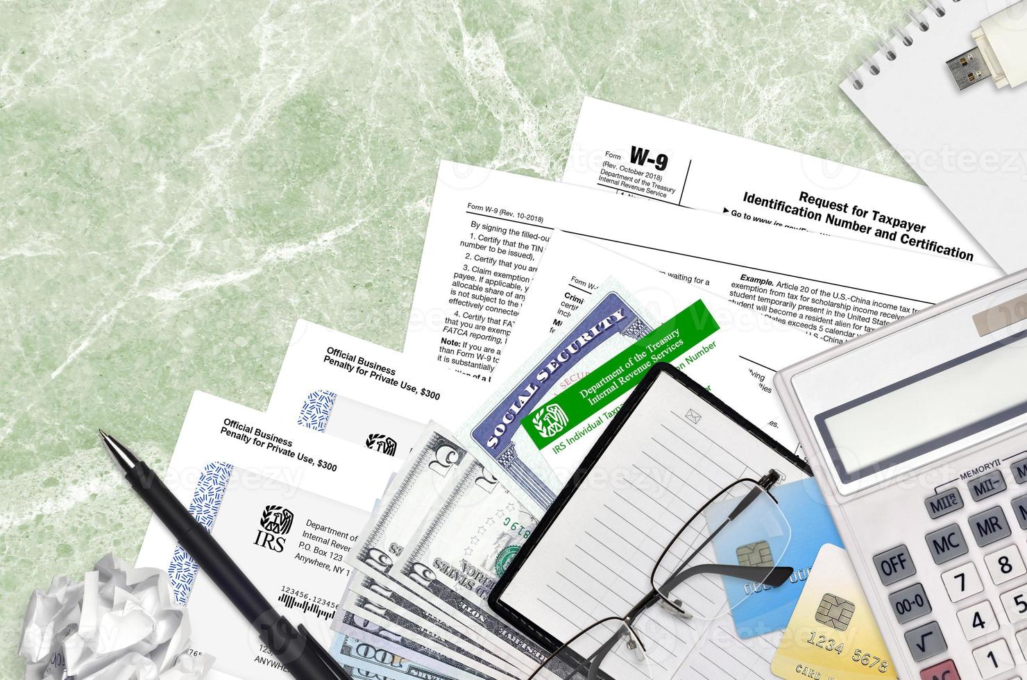IRS form W-9 Request for taxpayer identification number and certification lies on flat lay office table and ready to fill. U.S. Internal revenue services paperwork concept photo