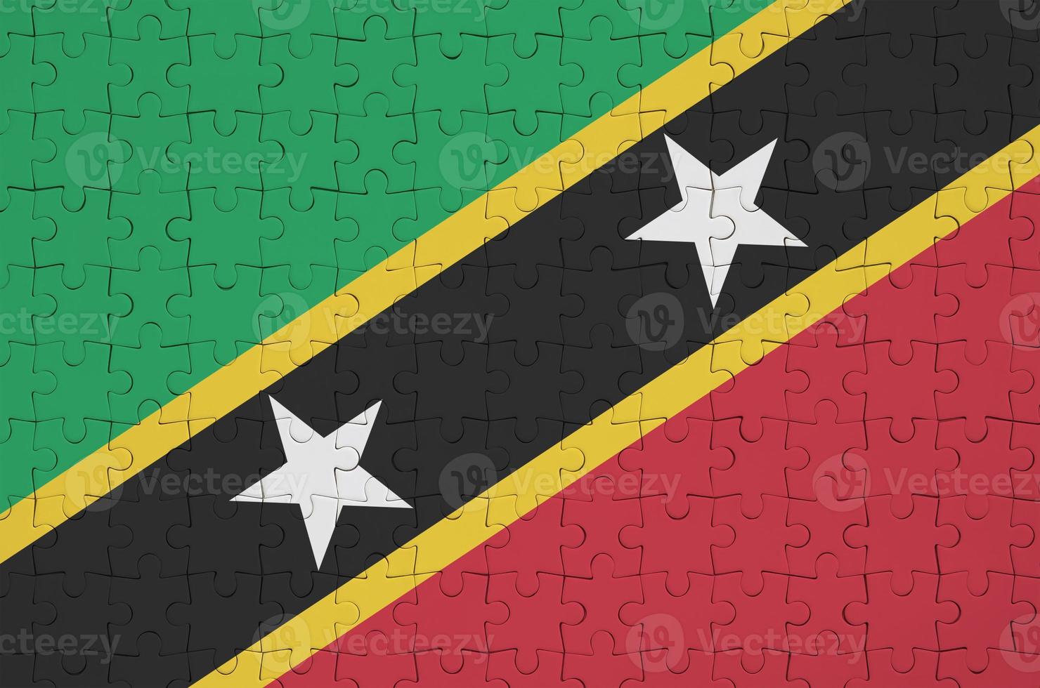 Saint Kitts and Nevis flag  is depicted on a folded puzzle photo