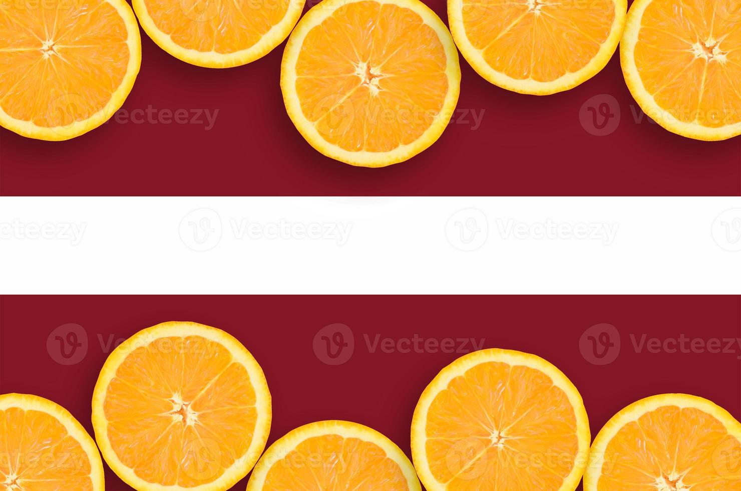 Latvia flag  in citrus fruit slices horizontal frame photo