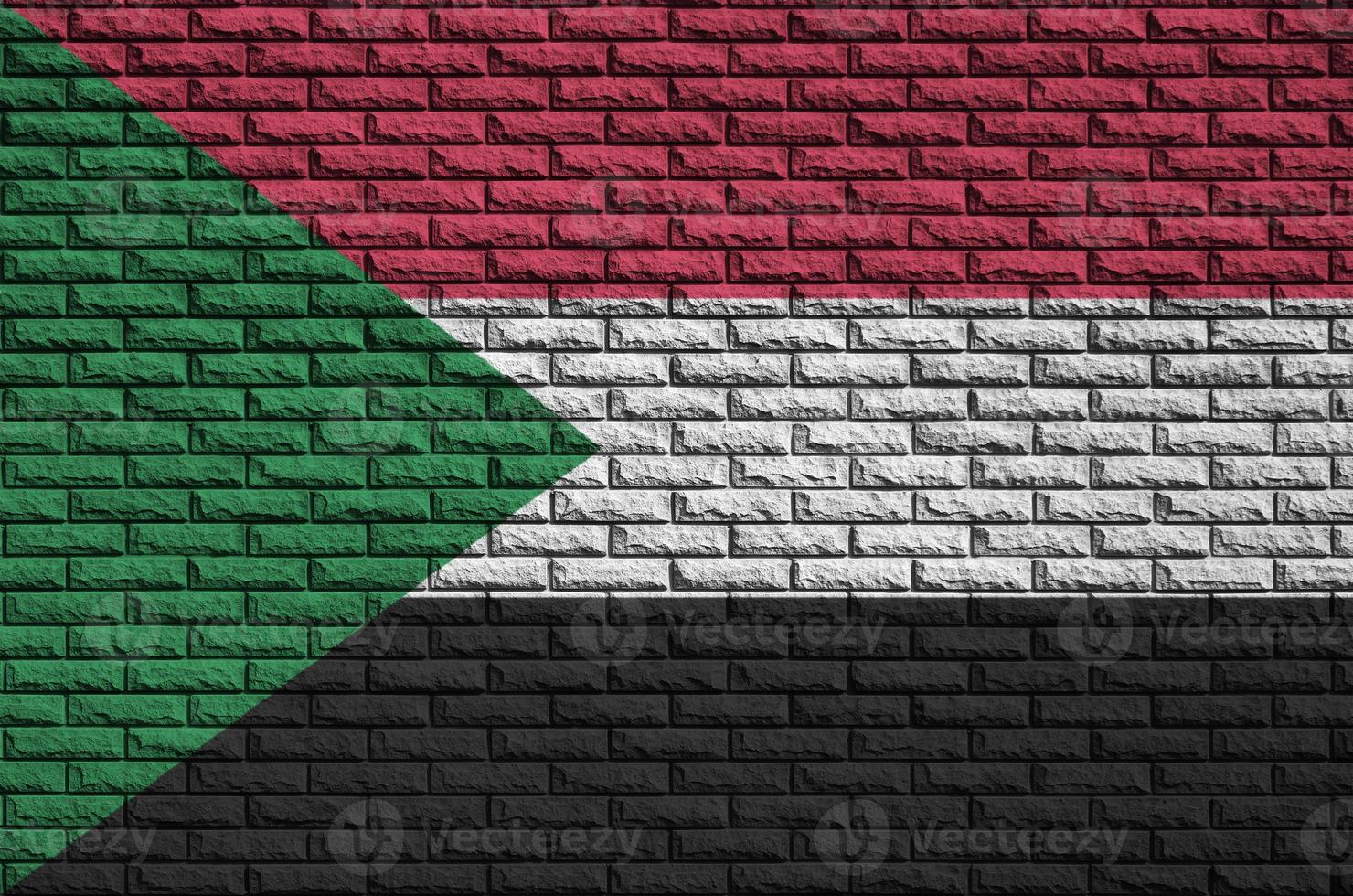 Sudan flag is painted onto an old brick wall photo