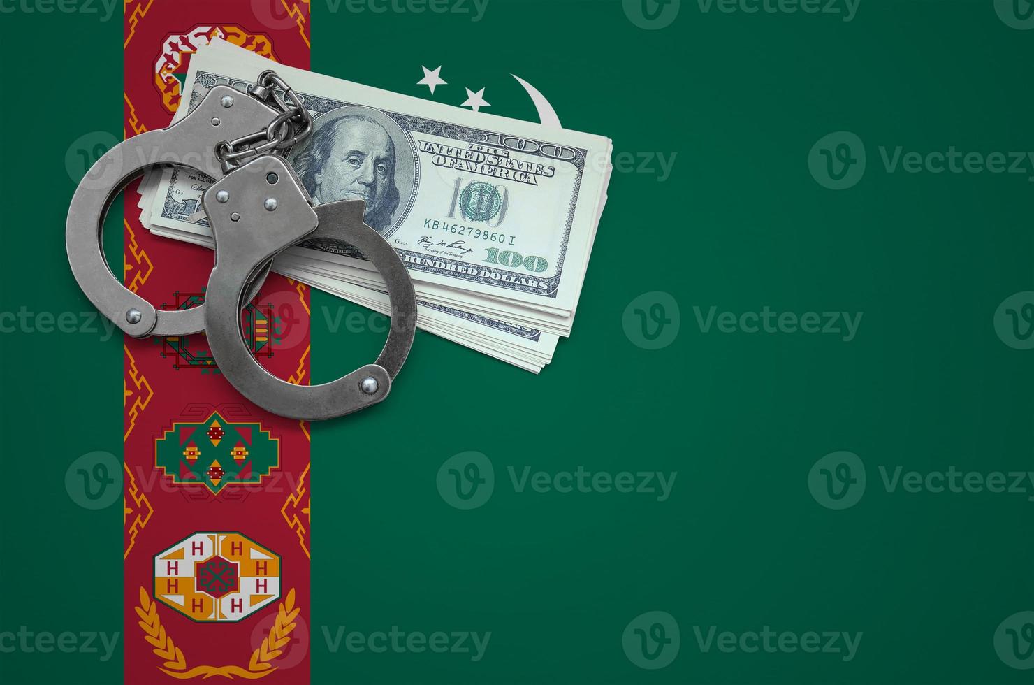 Turkmenistan flag  with handcuffs and a bundle of dollars. The concept of breaking the law and thieves crimes photo