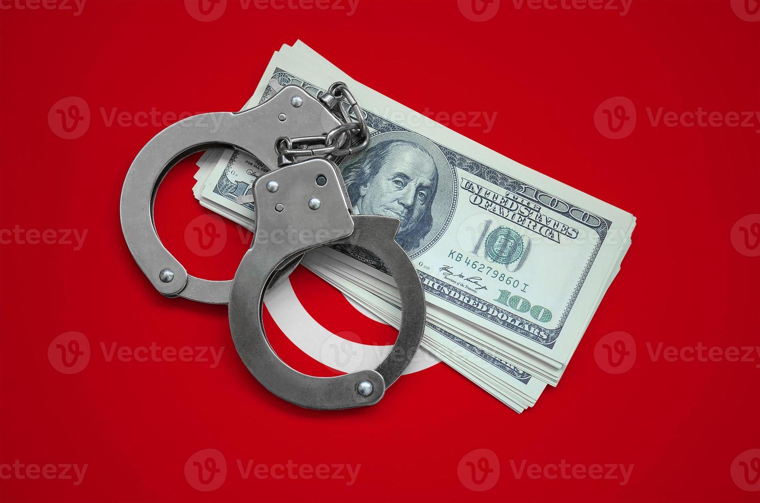 Tunisia flag  with handcuffs and a bundle of dollars. Currency corruption in the country. Financial crimes photo