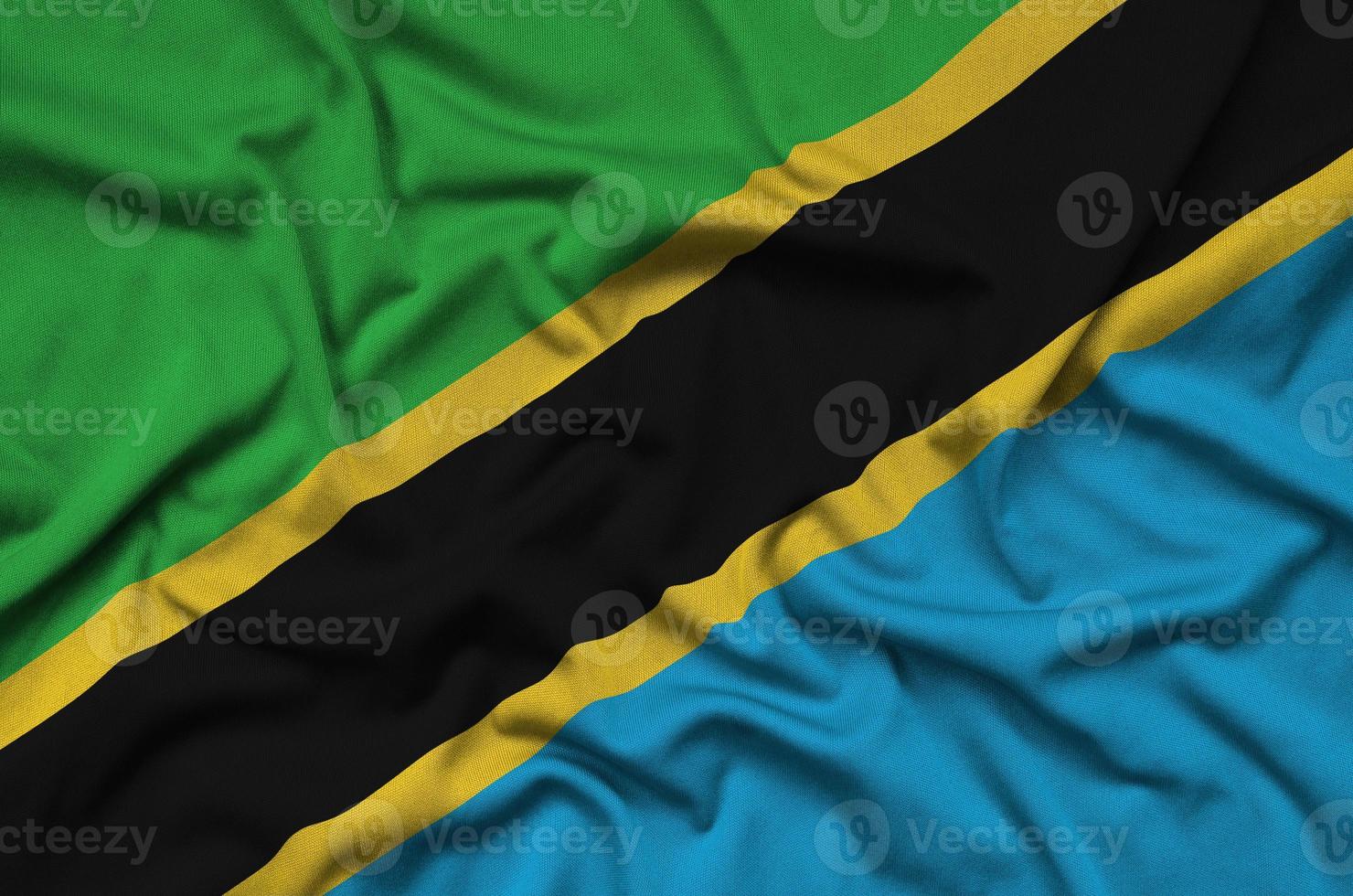 Tanzania flag  is depicted on a sports cloth fabric with many folds. Sport team banner photo