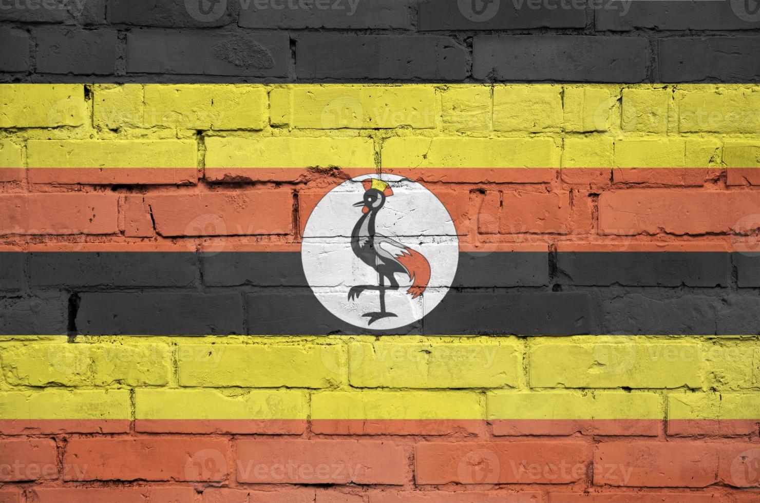 Uganda flag is painted onto an old brick wall photo