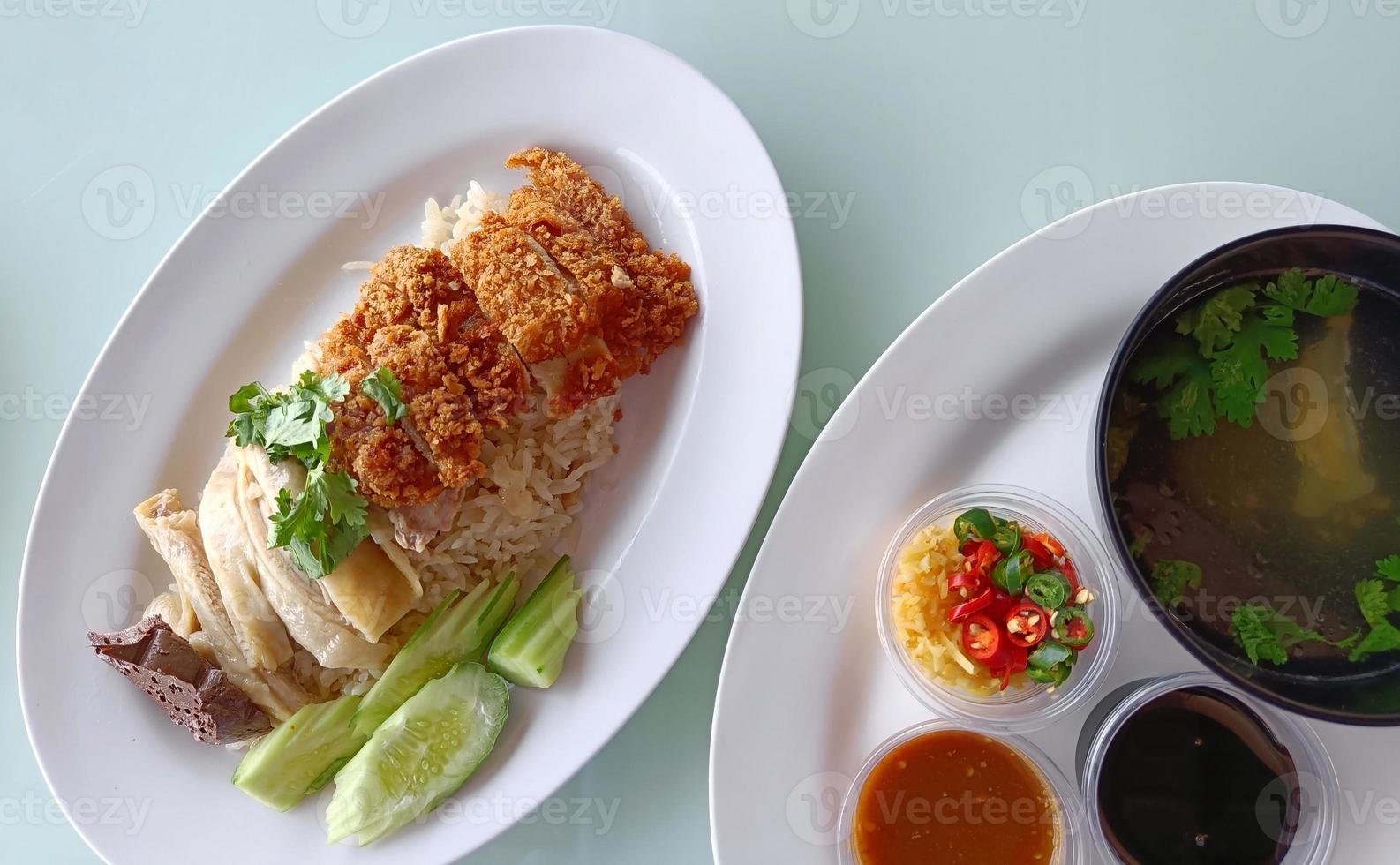 Boiled Chicken Rice Mixed with Fried Chicken Served with broth and dipping sauce, top view. The most popular street food in Thailand is called Khao Mun Gai. photo