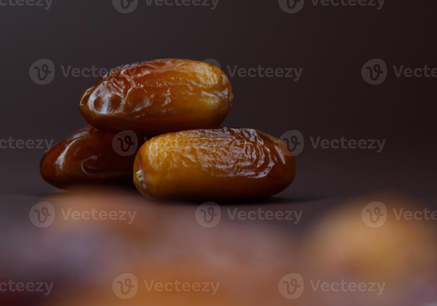 Dates lie on a brown background. Ripe dried dates. photo