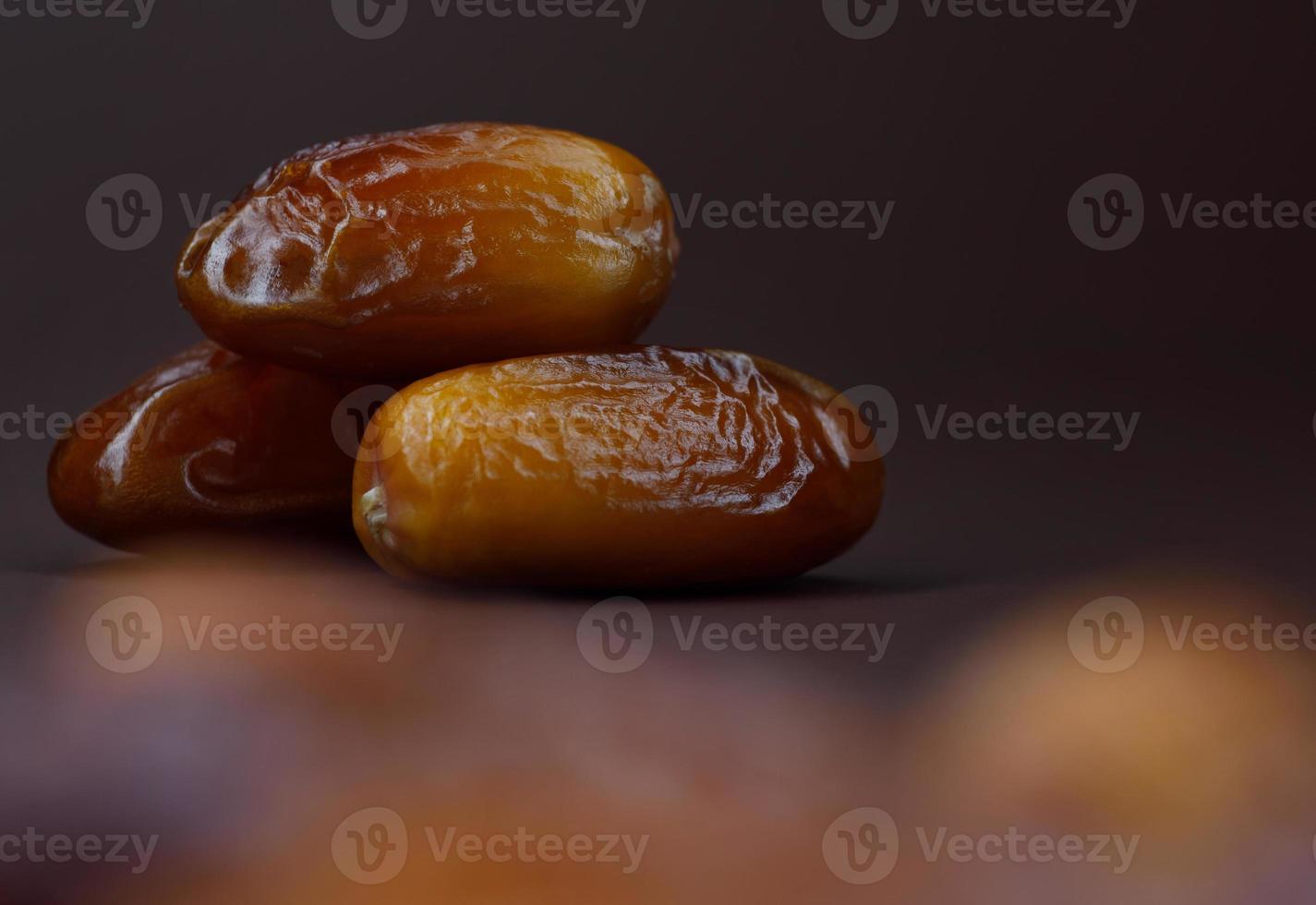 Dates lie on a brown background. Ripe dried dates. photo